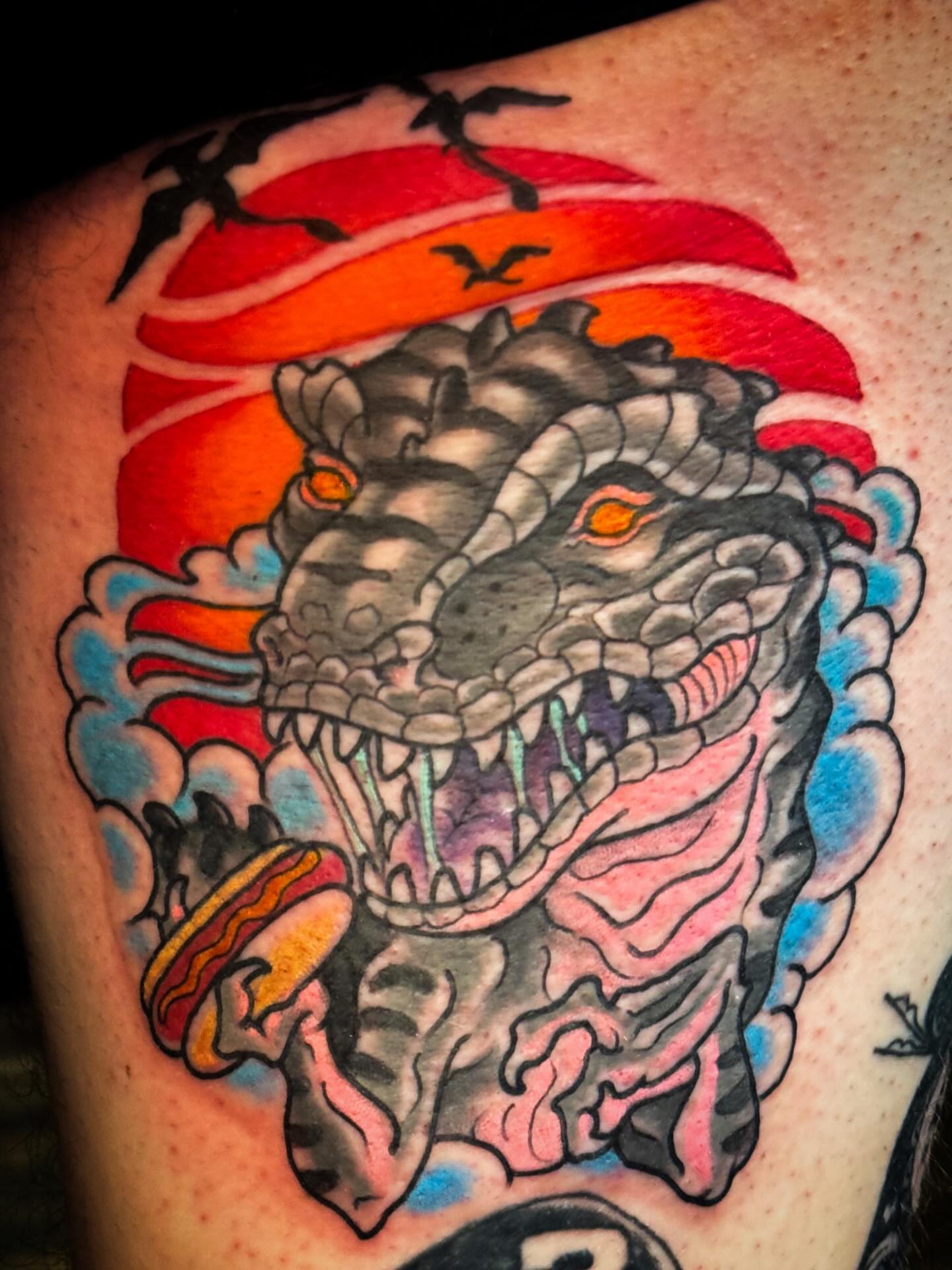 Dinosaur American traditional tattoo on the thigh by Bob Lackner