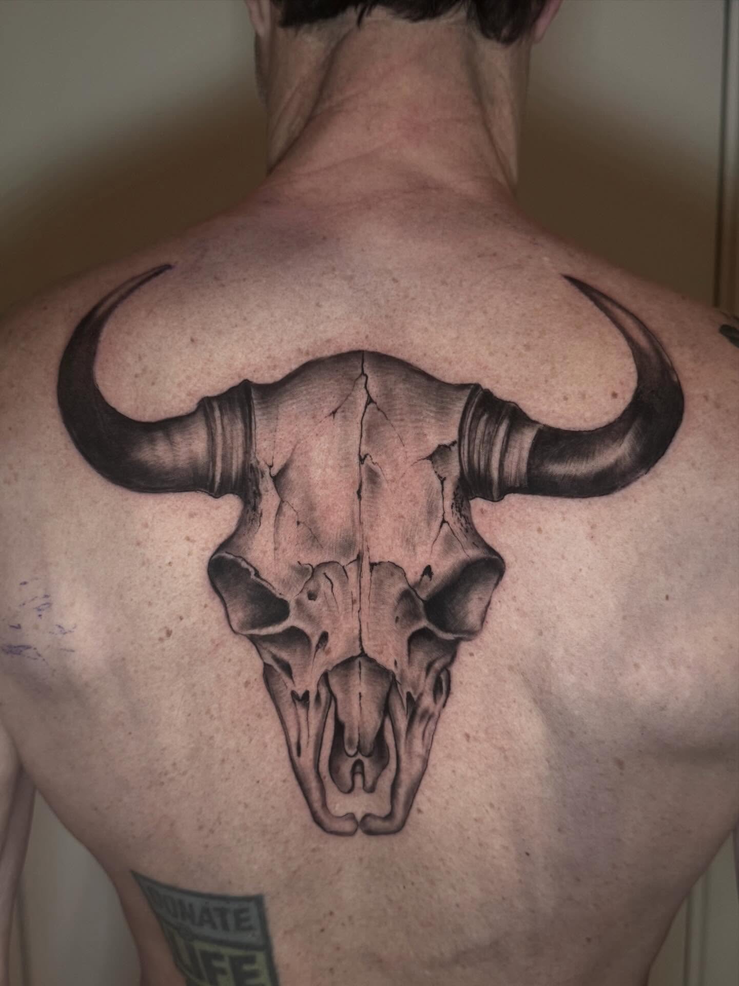 Bull skull realism tattoo on the back by Matthew Crawley
