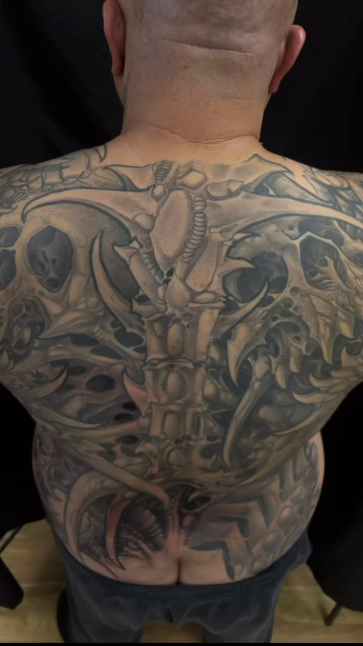 Biomechanical horror dark realism tattoo by Rene Chavira