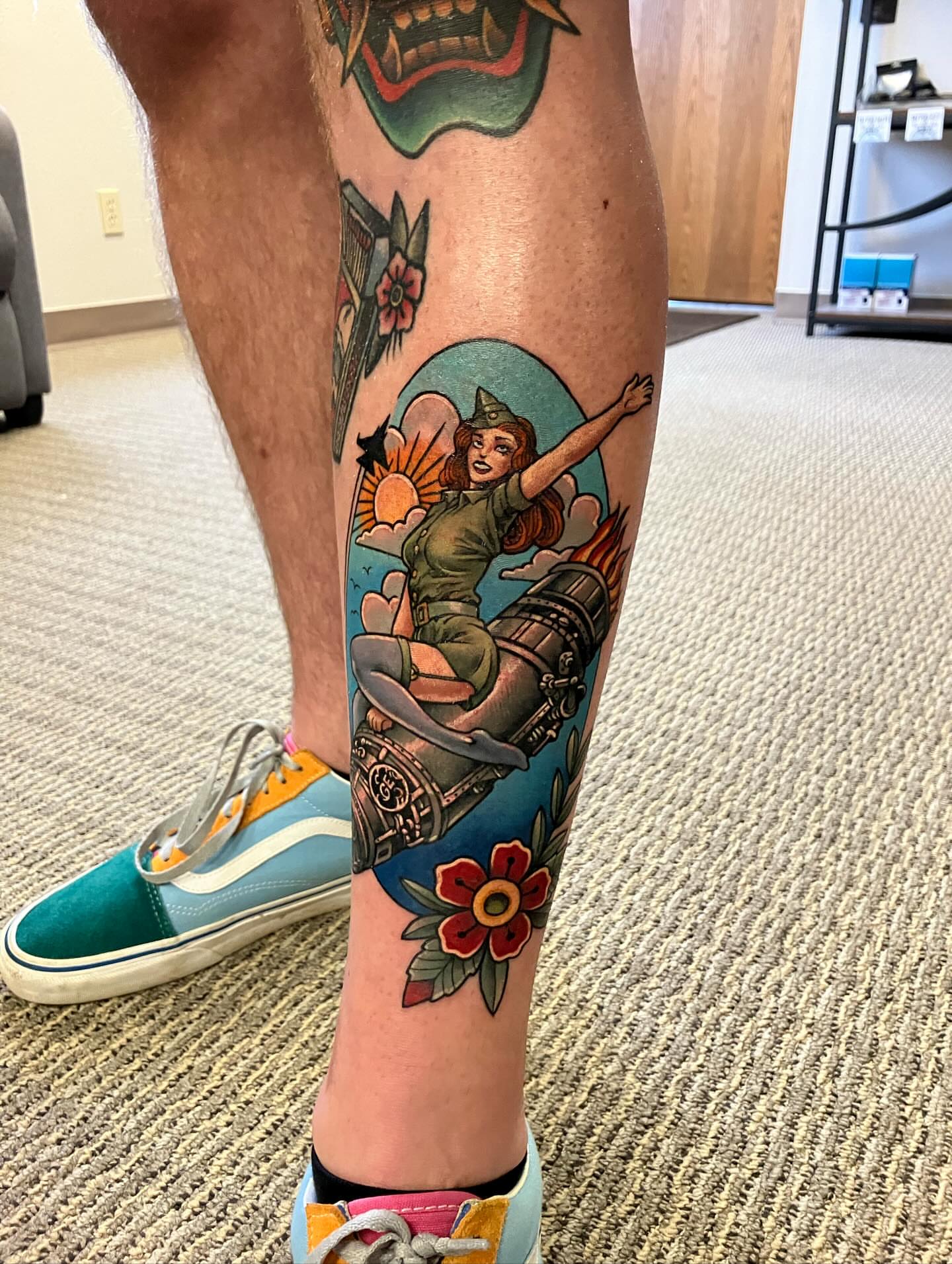 Woman on motorcycle American traditional tattoo on the calf by Alexander L. Wolff, Rapid City, South Dakota