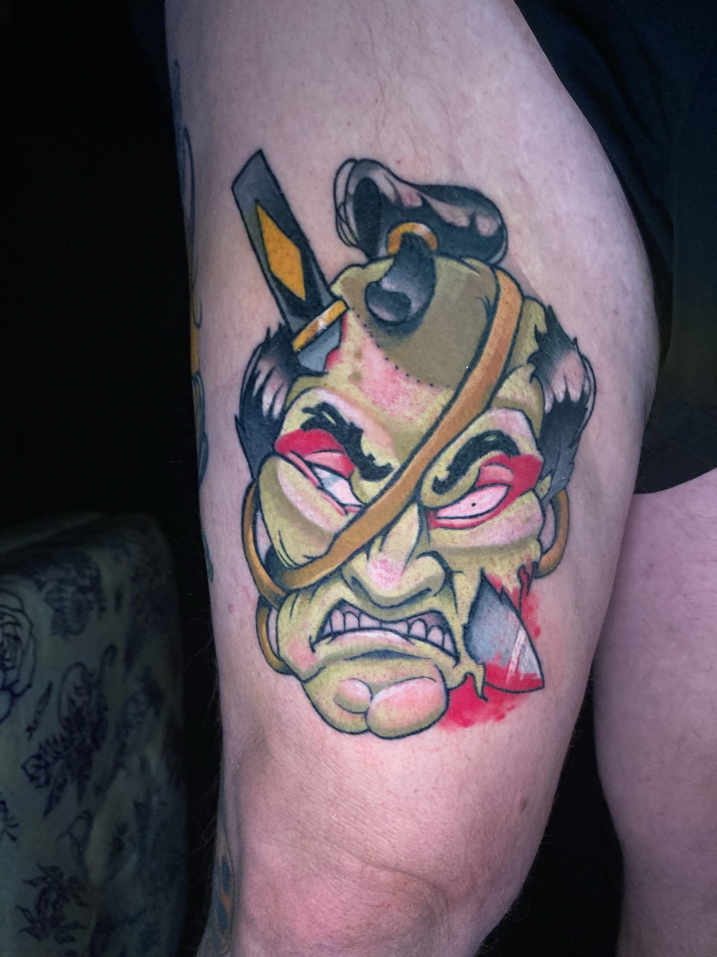 Angry warrior mask American traditional tattoo on the thigh by Eathan Hale-(East TN) Newschool Tattoo Artist