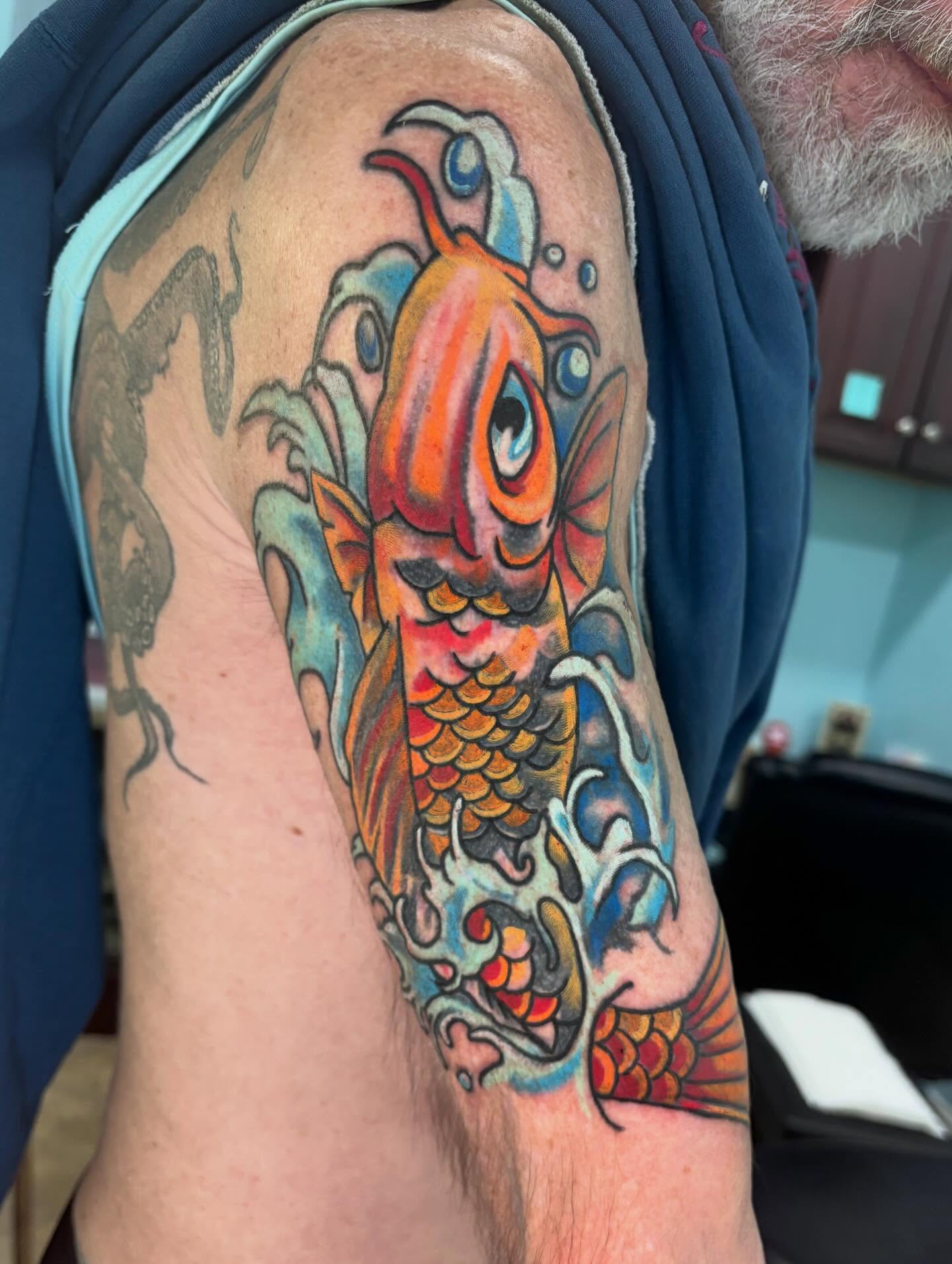 Koi fish japanese irezumi tattoo on the upper arm by Stephanie Rowe