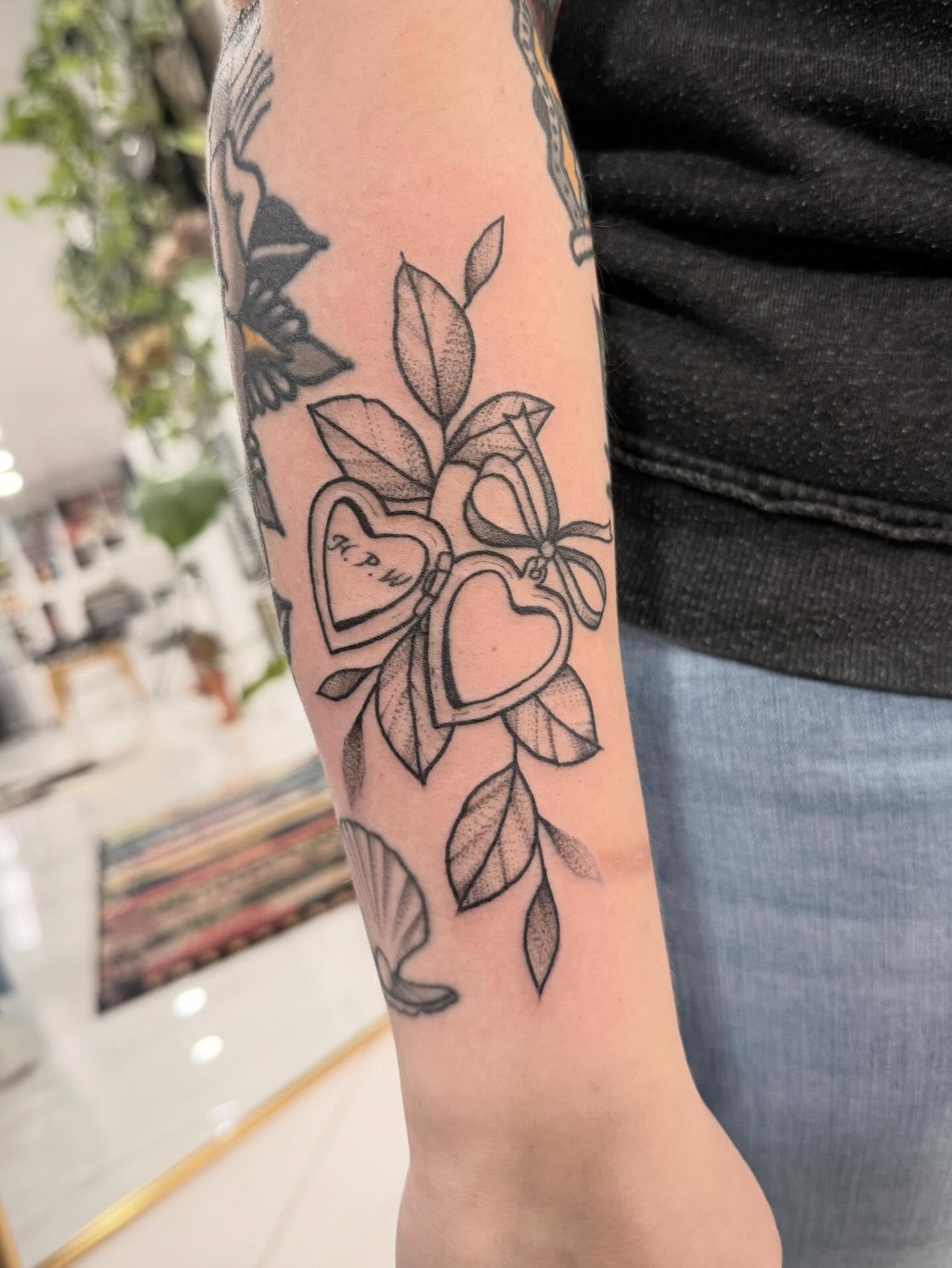Hearts and leaves dotwork tattoo on the forearm by Shannon Misitano