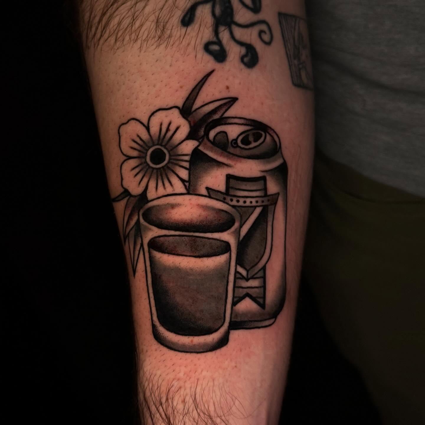 Coffee cup and flowers American traditional tattoo on the forearm by Mallory Brown