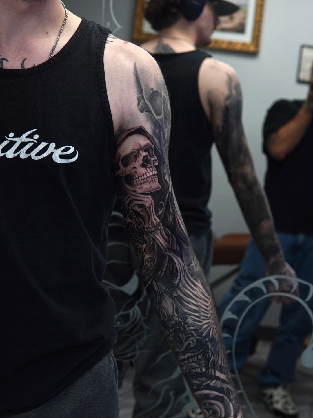 Skull and wings realism tattoo on the upper arm by Sebastian