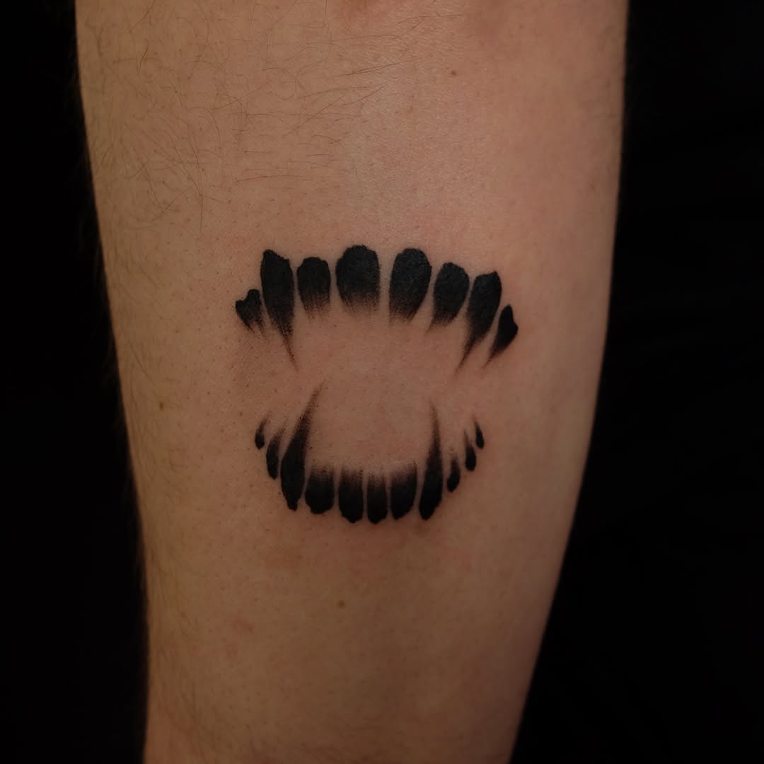 Vampire fangs dark art tattoo on the forearm by lela