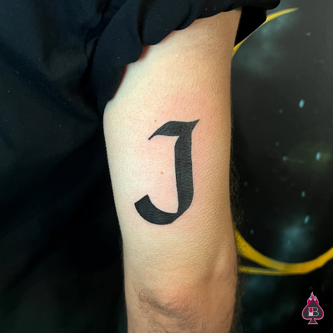 Letter J lettering tattoo on the forearm by BRIK RANGEL - Tattoo Artist