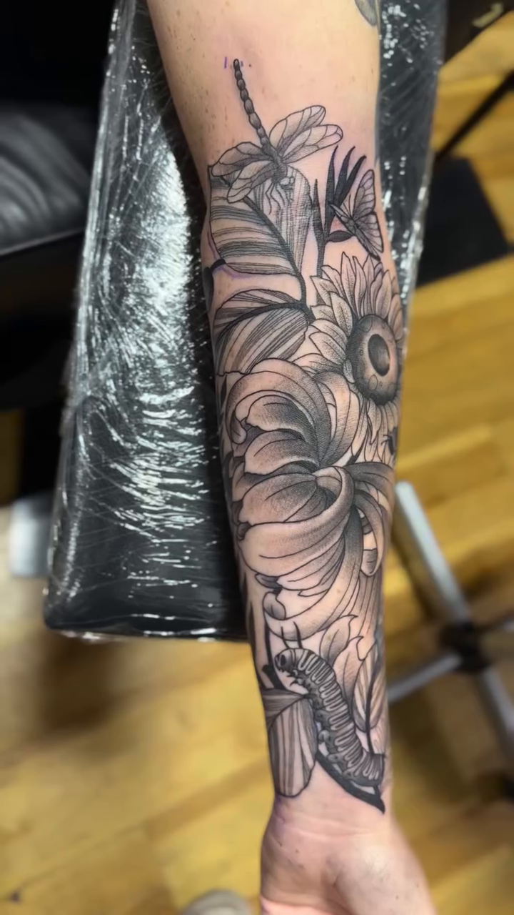 Floral arrangement with dragonfly realism tattoo by H.G
