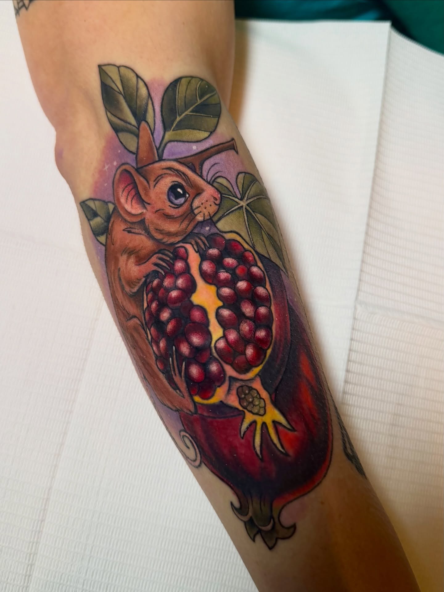 Pomegranate and mouse realism tattoo on the forearm by Tattoos By Lola Cavotta, Willoughby, Ohio