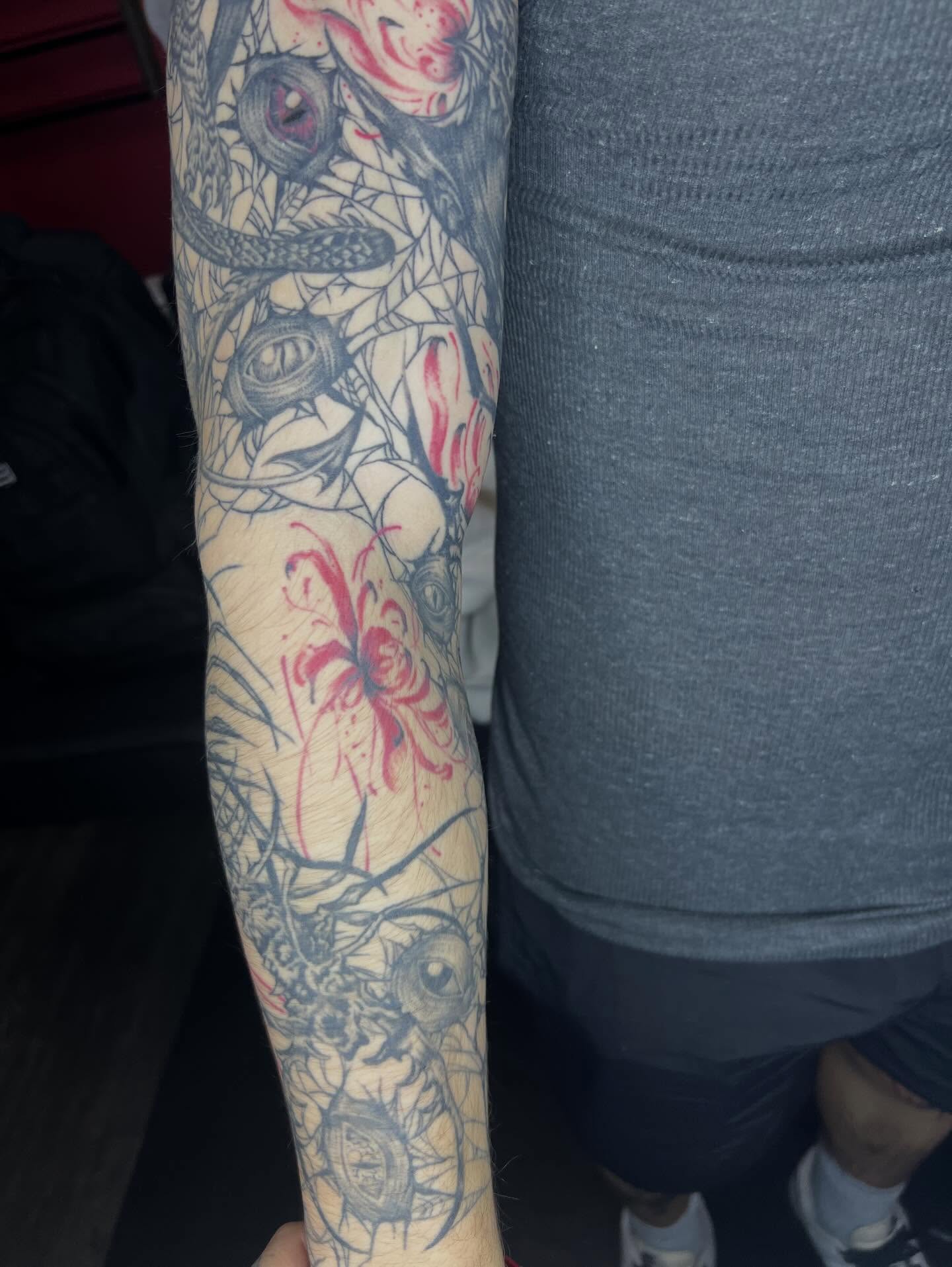 Spiderweb and floral dotwork tattoo on the forearm by Dark Luna Tattoos LLC