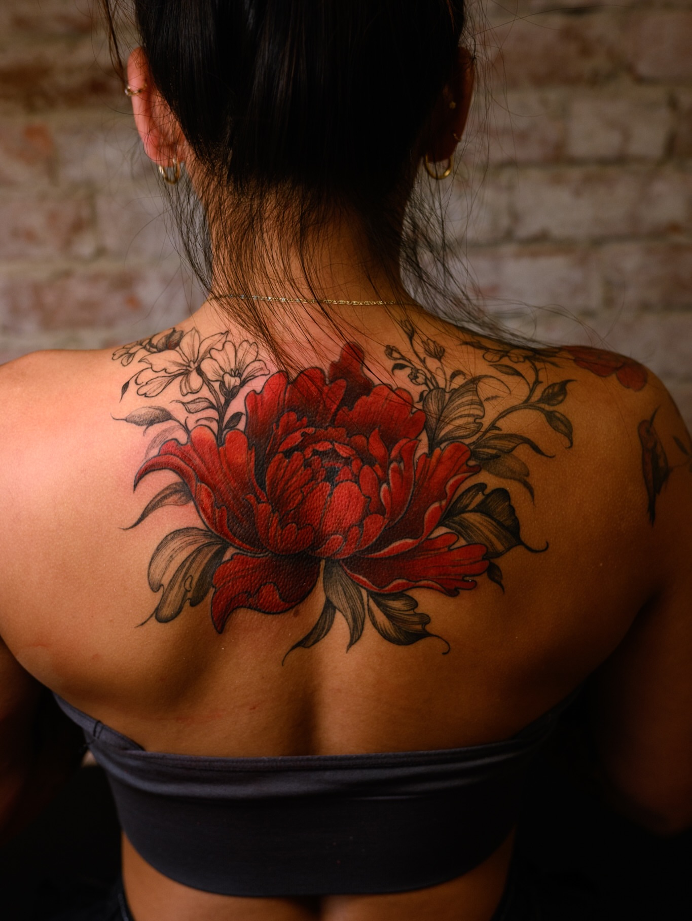 Peony realism tattoo on the back by Brad Simmons