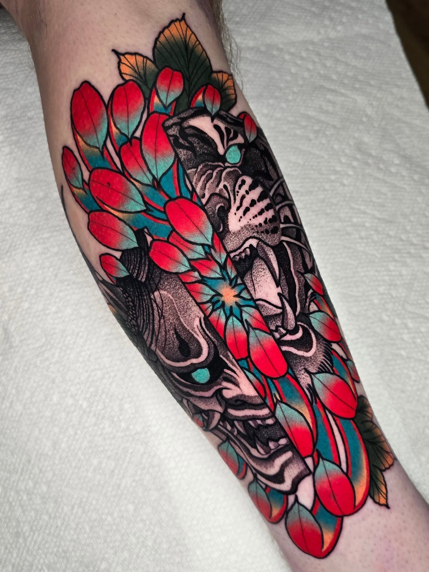 Mask and flowers japanese irezumi tattoo on the forearm by Justin Eldridge