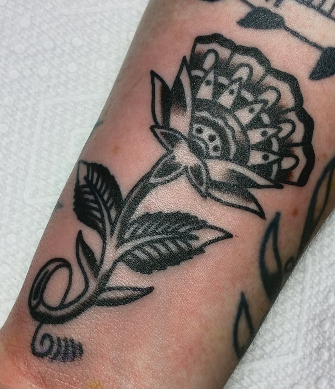 Flower dotwork tattoo on the forearm by Sav Robinson