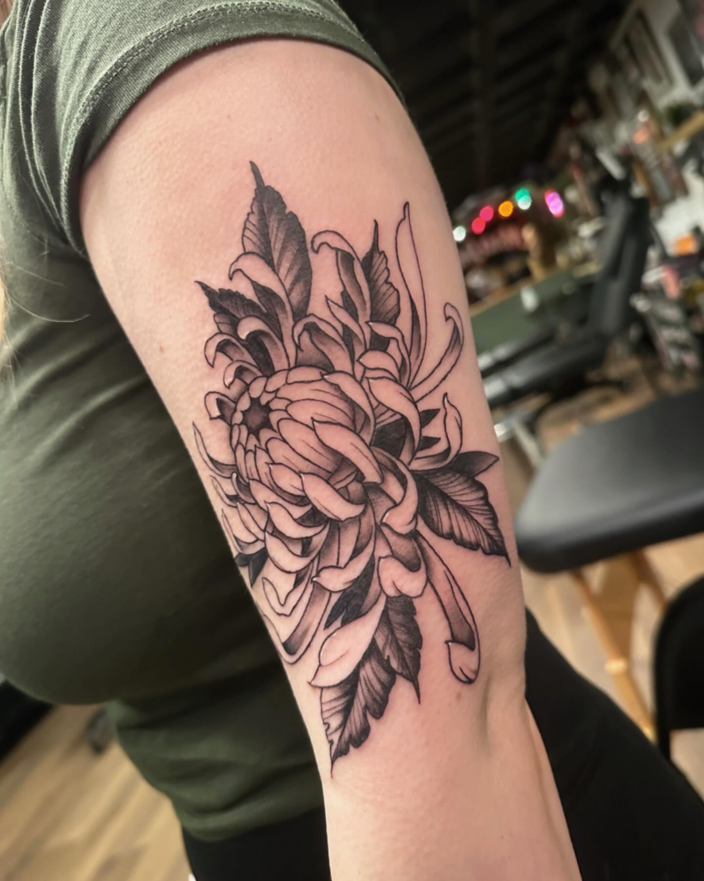 Chrysanthemum black and grey tattoo on the forearm by Craig Ryans