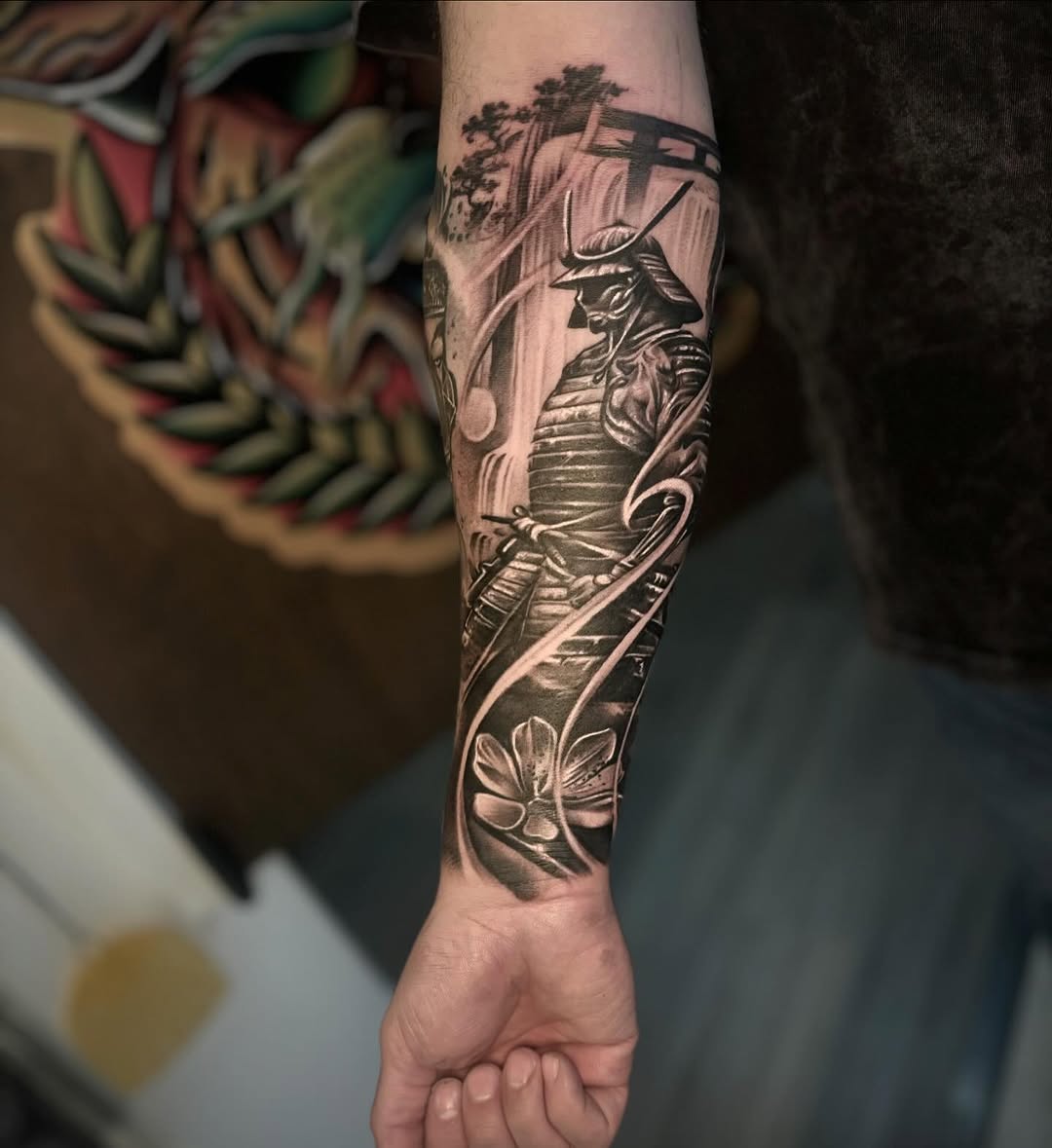 Samurai warrior with waterfall and flower realism tattoo on the forearm by ๐๐๐๐๐๐๐ ๐ฌ.๐ผ