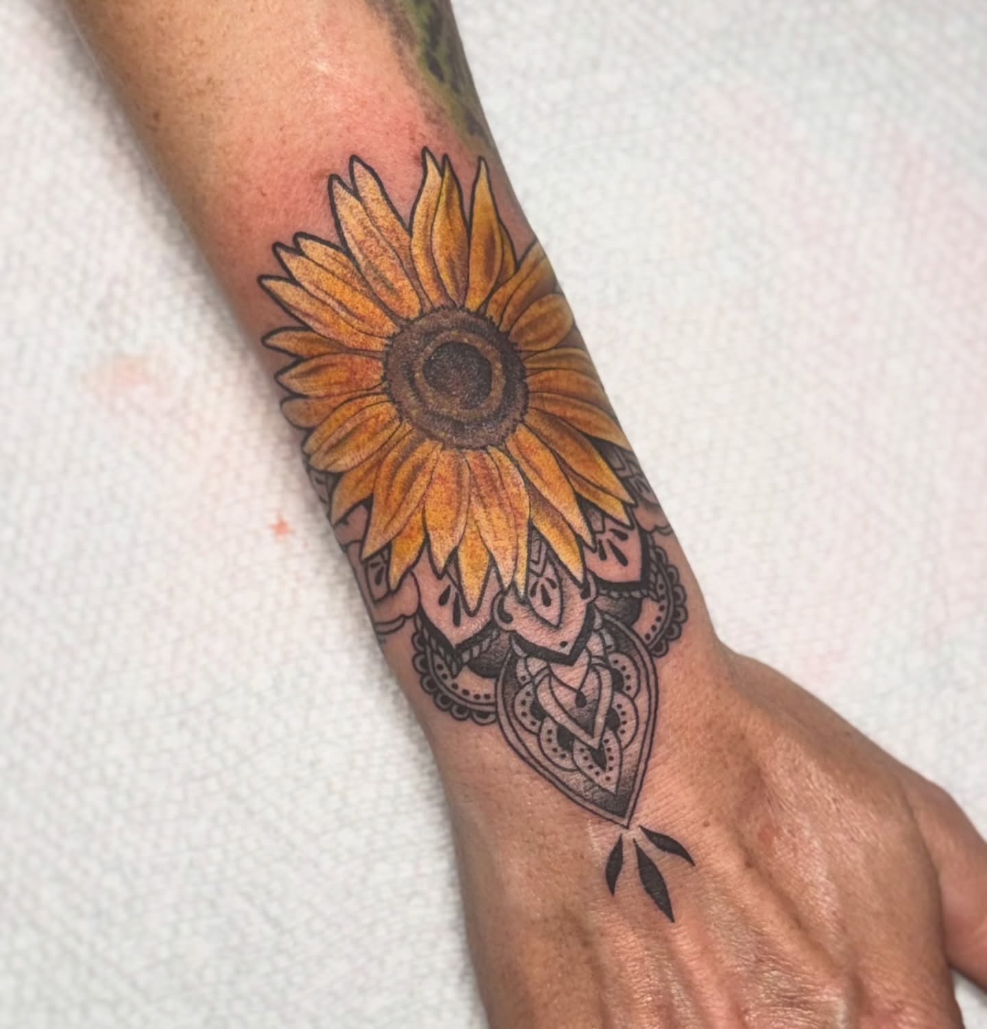Sunflower black and grey tattoo on the forearm by Lyndze Masters