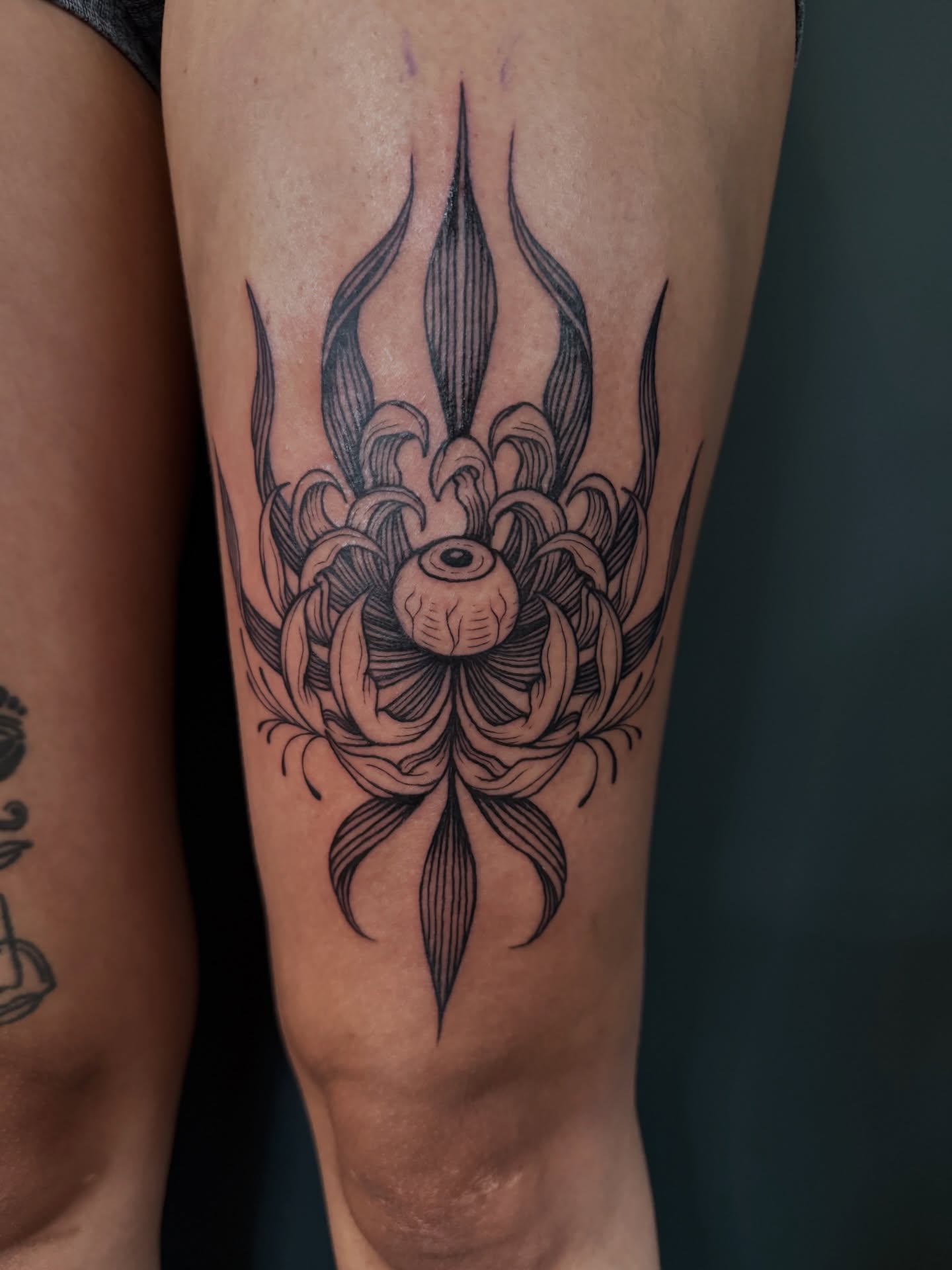 Lotus flower black and grey tattoo on the calf by Paul DeVay