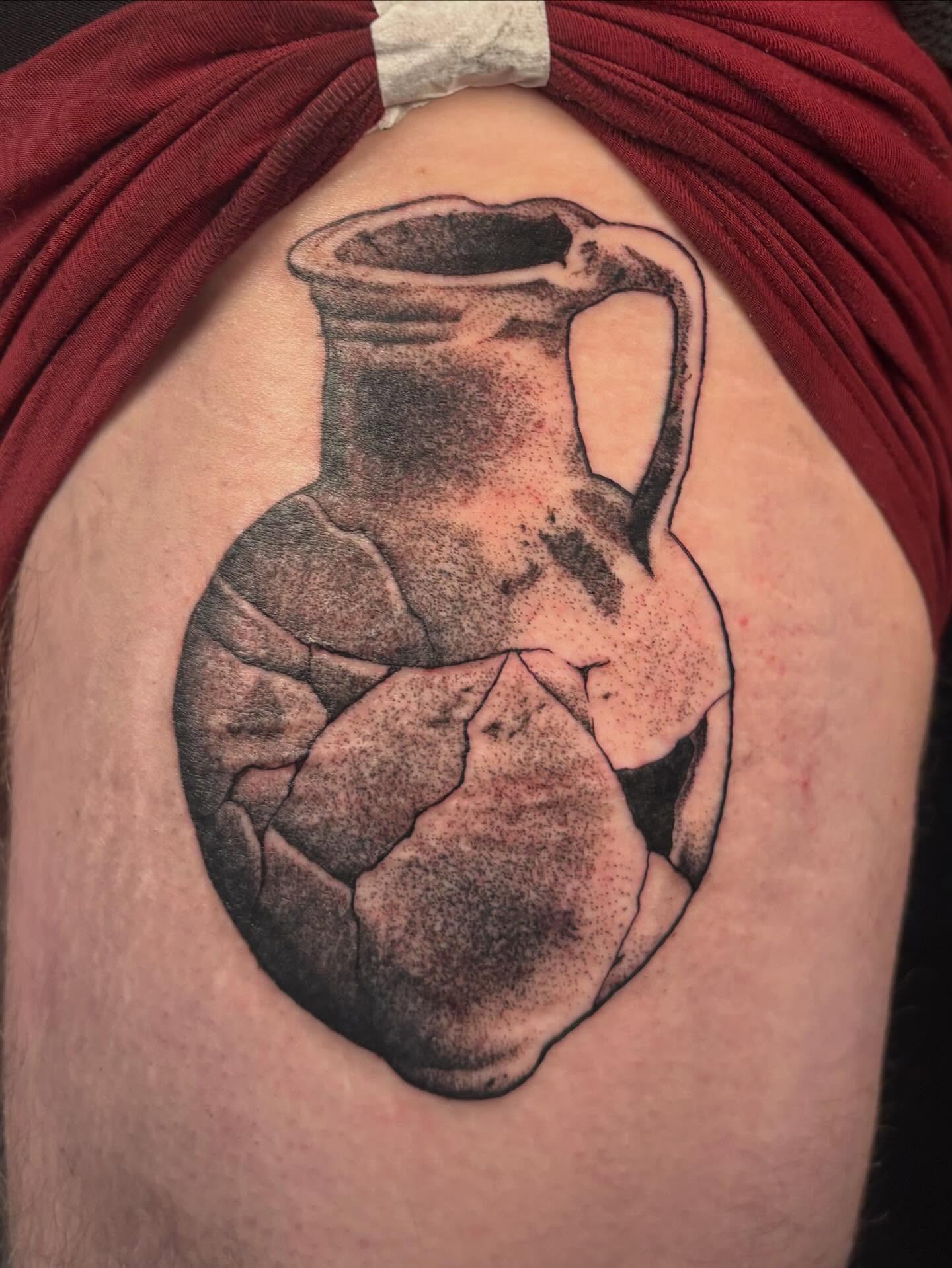 Cracked pitcher black and grey tattoo on the shoulder by Nolan Croteau