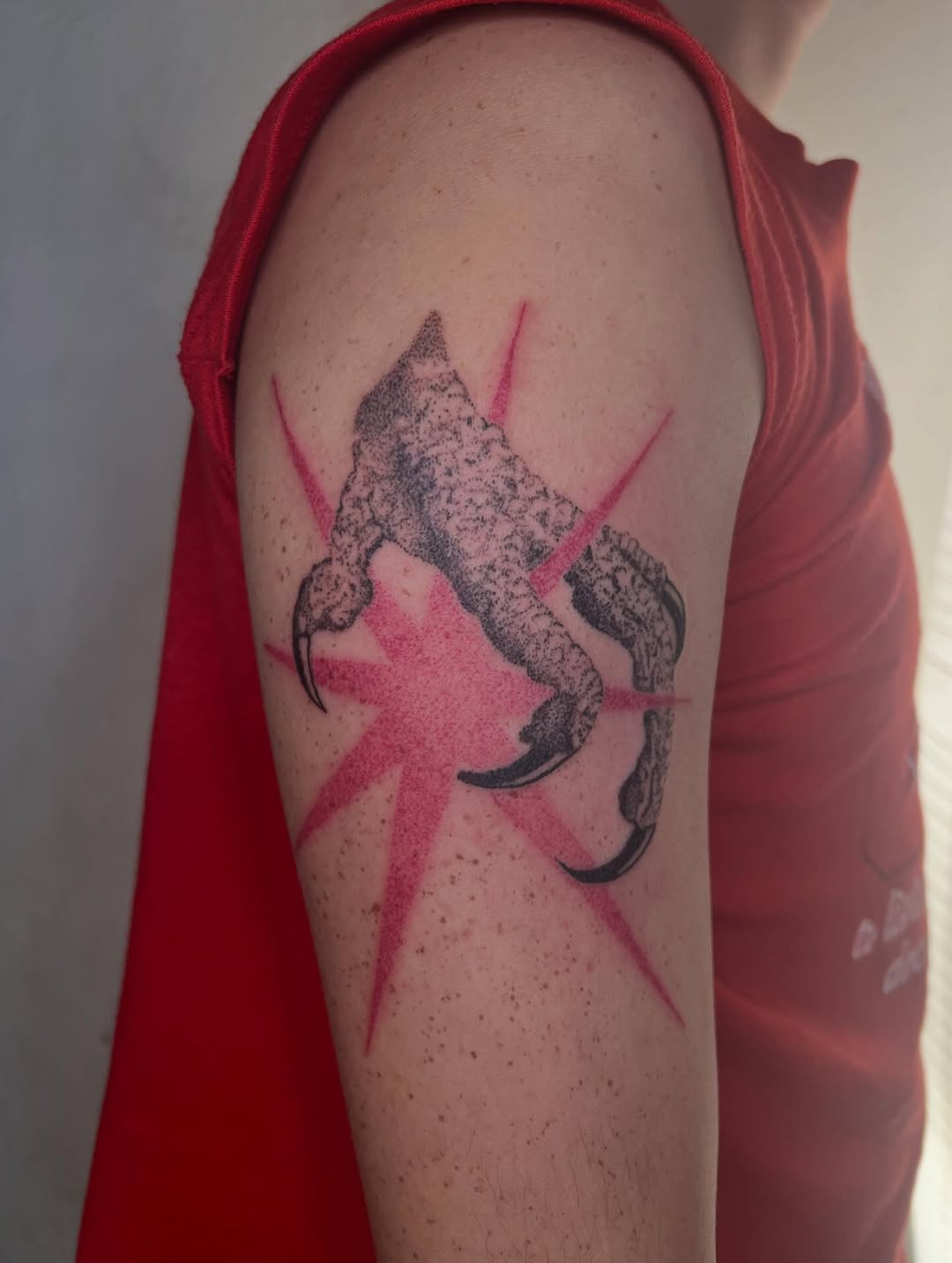 Bird claw realism tattoo on the upper arm by faith