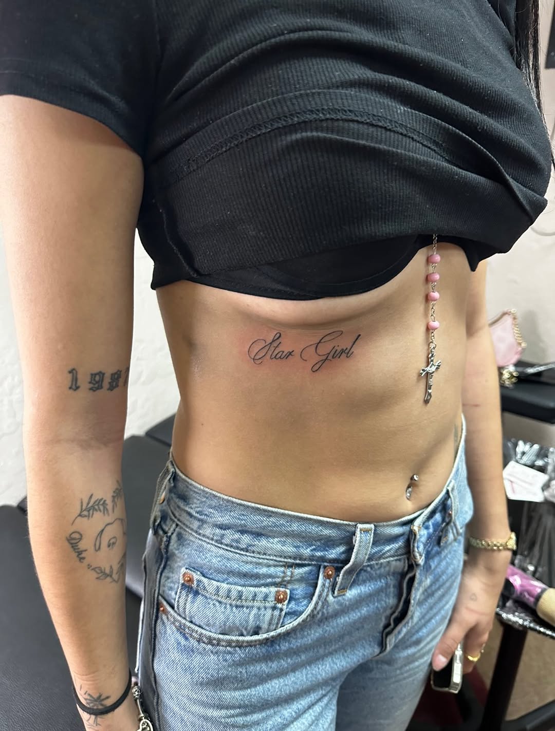 Star Girl text lettering tattoo on the torso by Lupita Ink