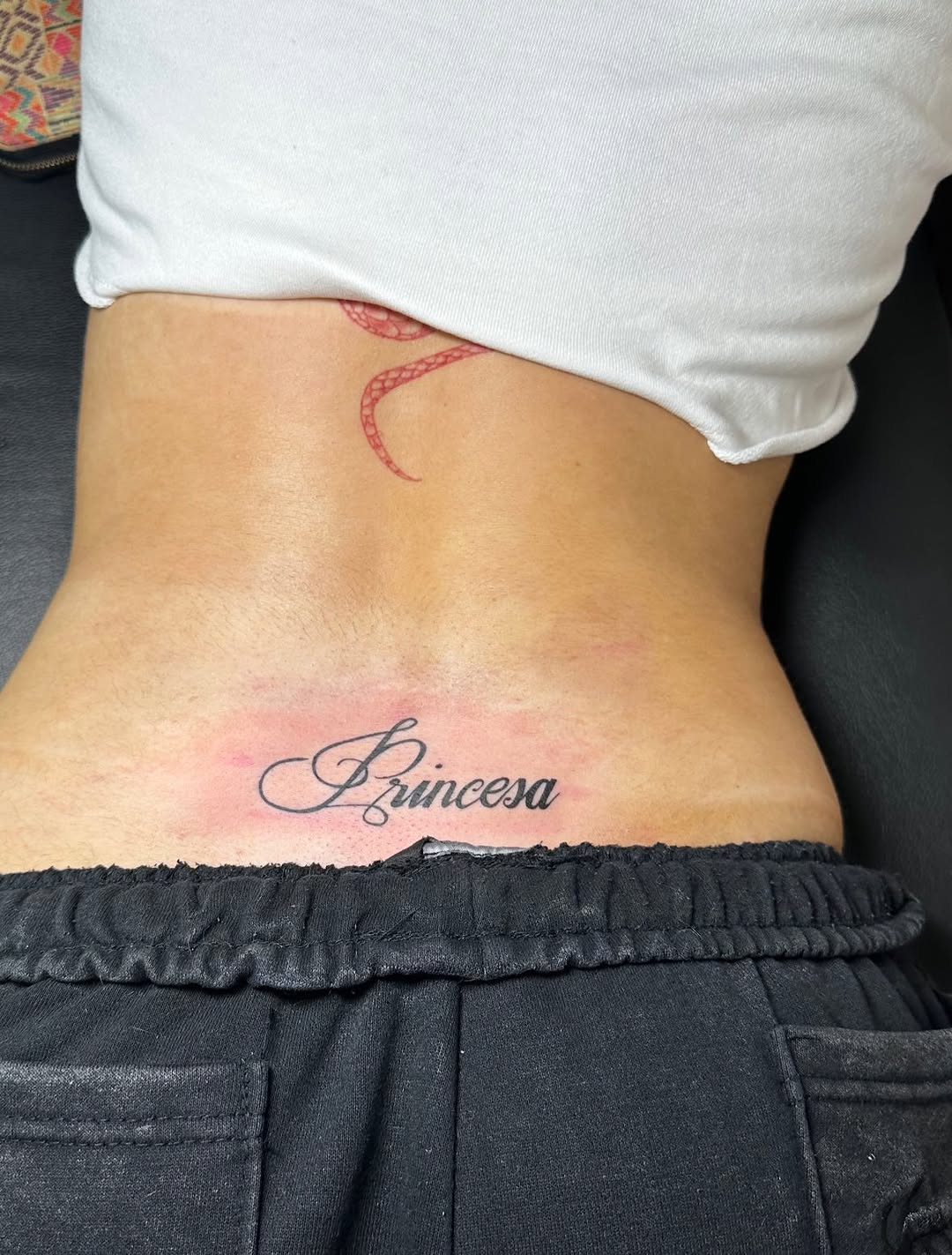 Princesa script tattoo lettering tattoo on the torso by Lupita Ink