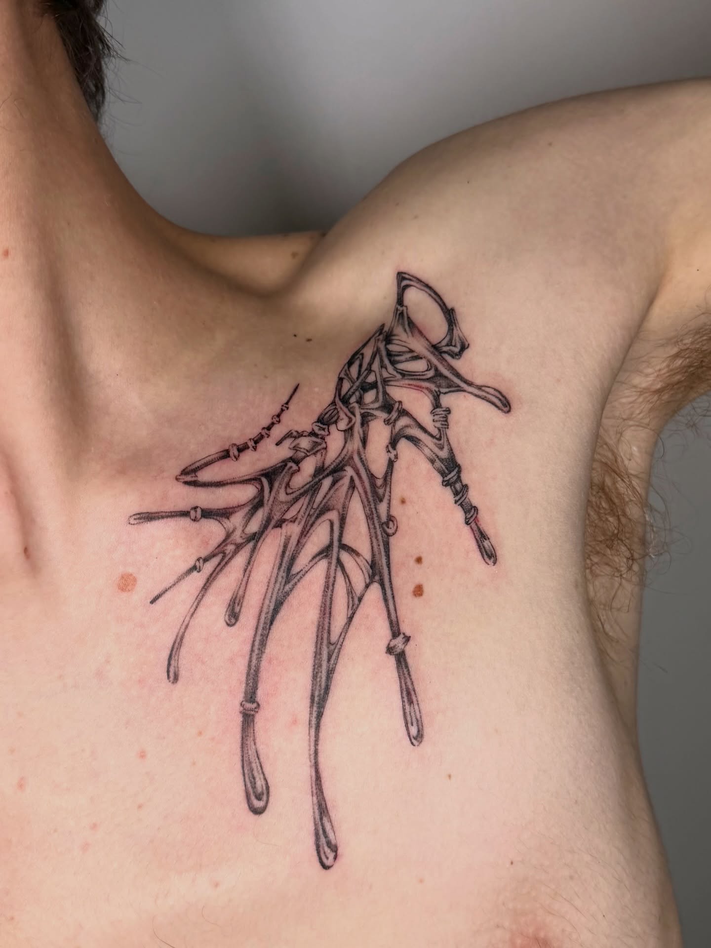 Antlers black and grey tattoo on the chest by Lauren ๐