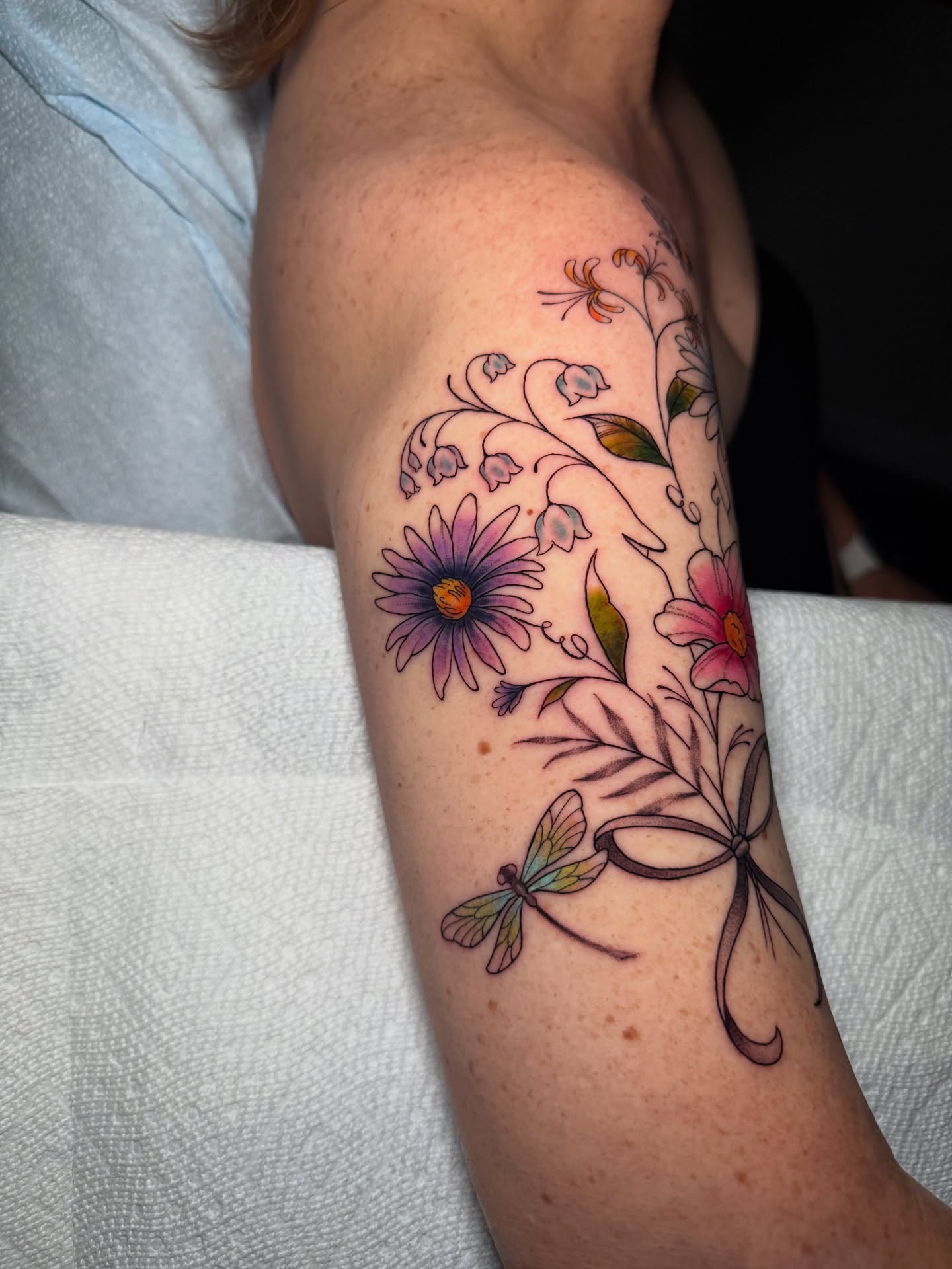 Floral arrangement with dragonfly new school tattoo on the forearm by 𝕹𝖆𝖙