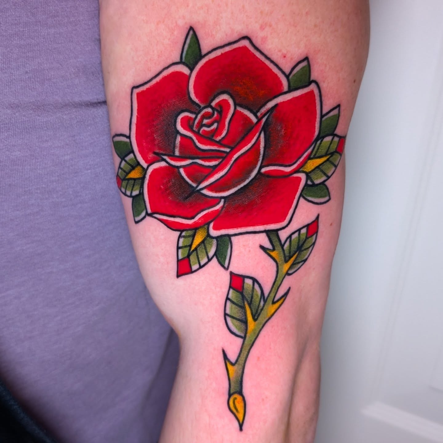Red rose American traditional tattoo on the thigh by Erik O'Steen, Medford, Massachusetts