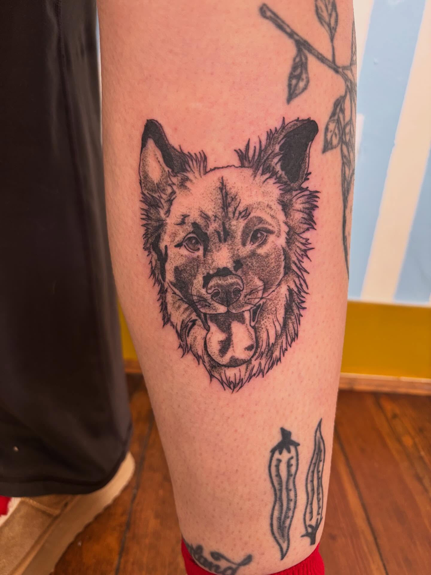 Dog head black and grey tattoo on the forearm by Ashley Ellerman