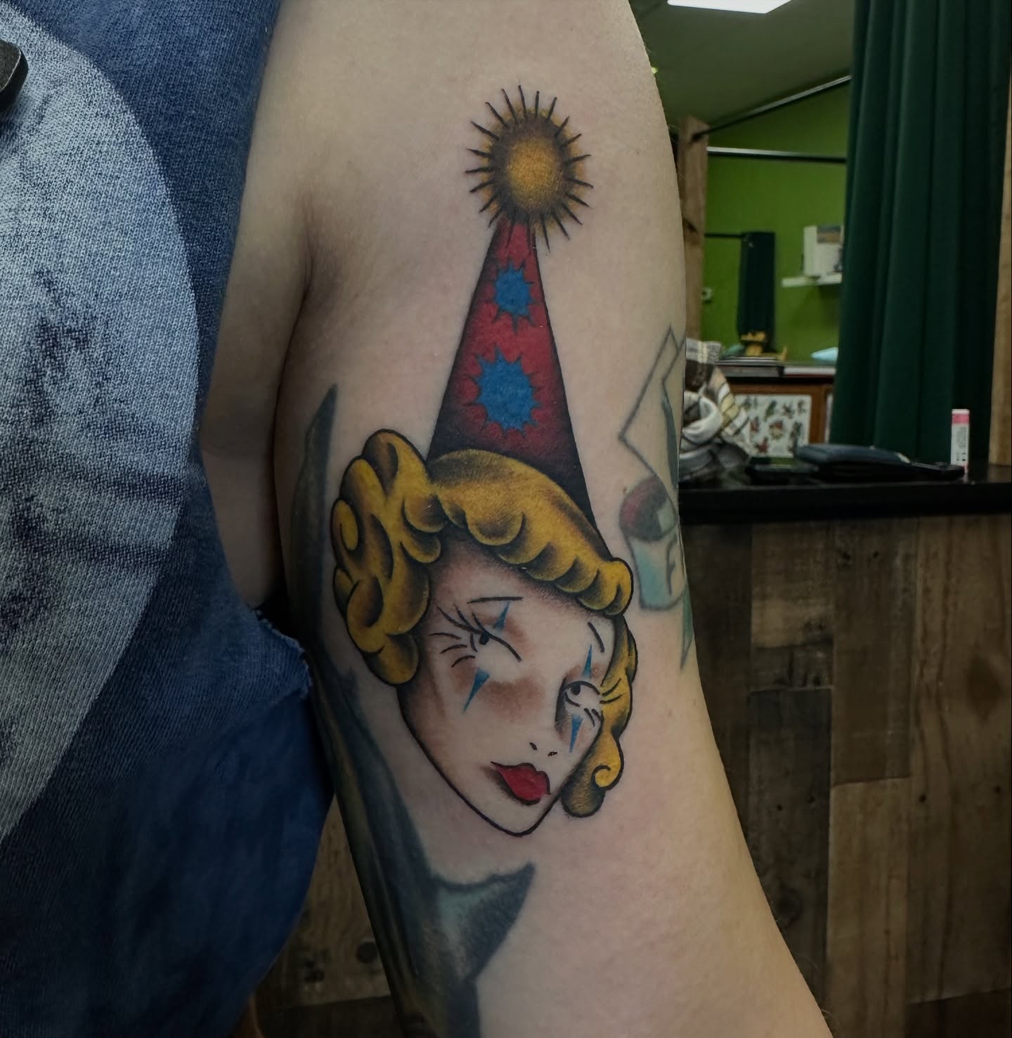 Jester American traditional tattoo on the forearm by Sam Minneci