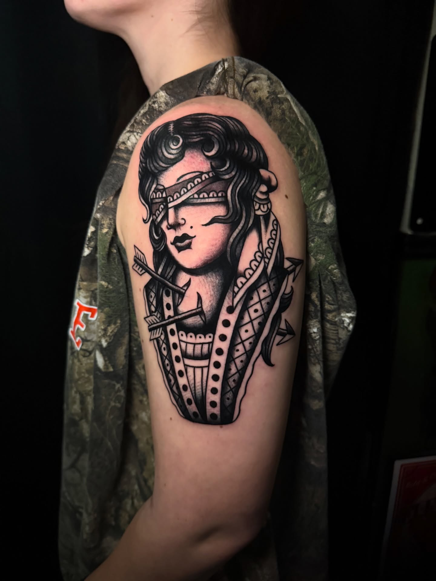 Woman with blindfold American traditional tattoo on the shoulder by Brandon Bear