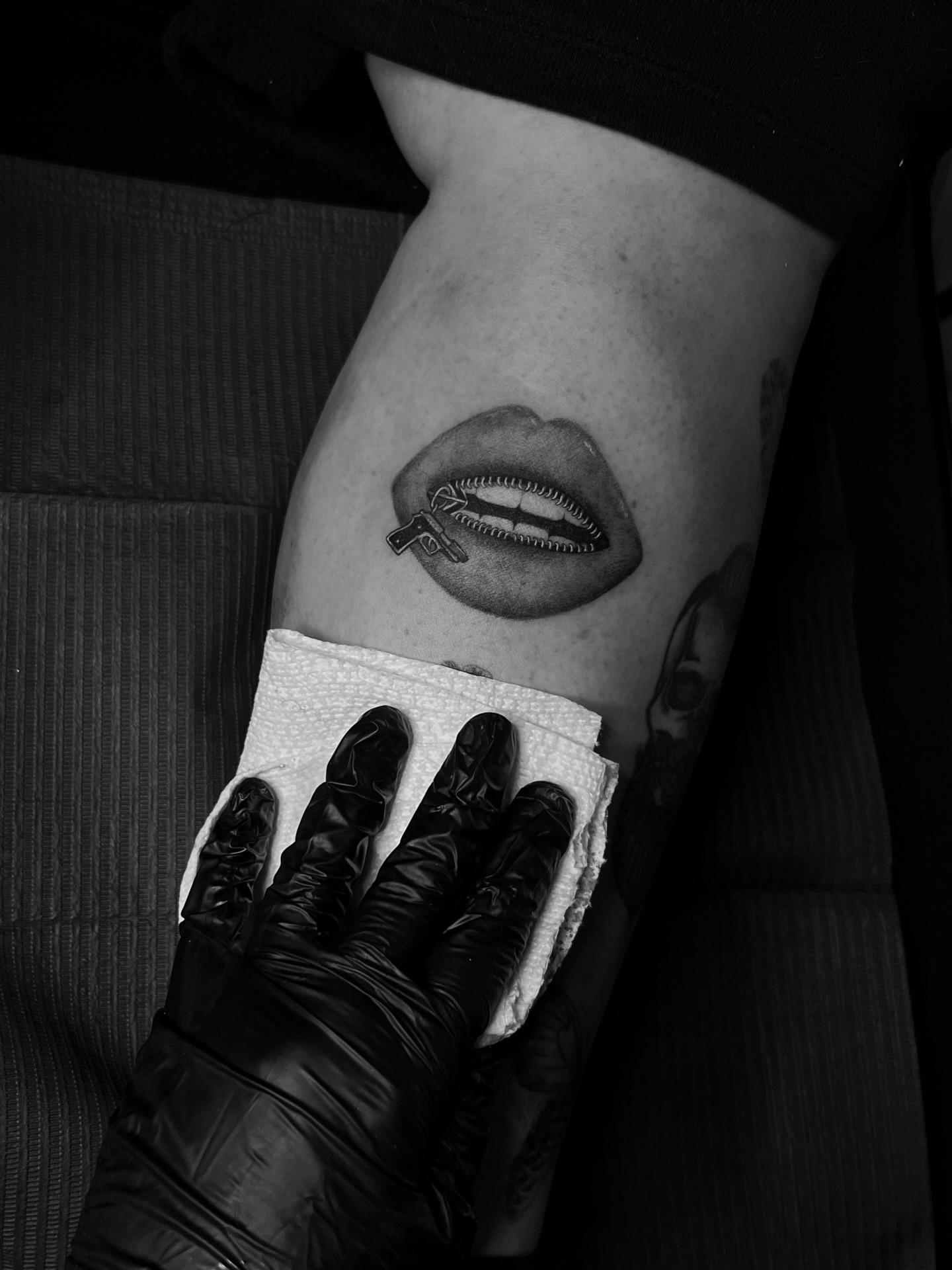Lips with gun realism tattoo on the thigh by Lina Valentina, New York, New York