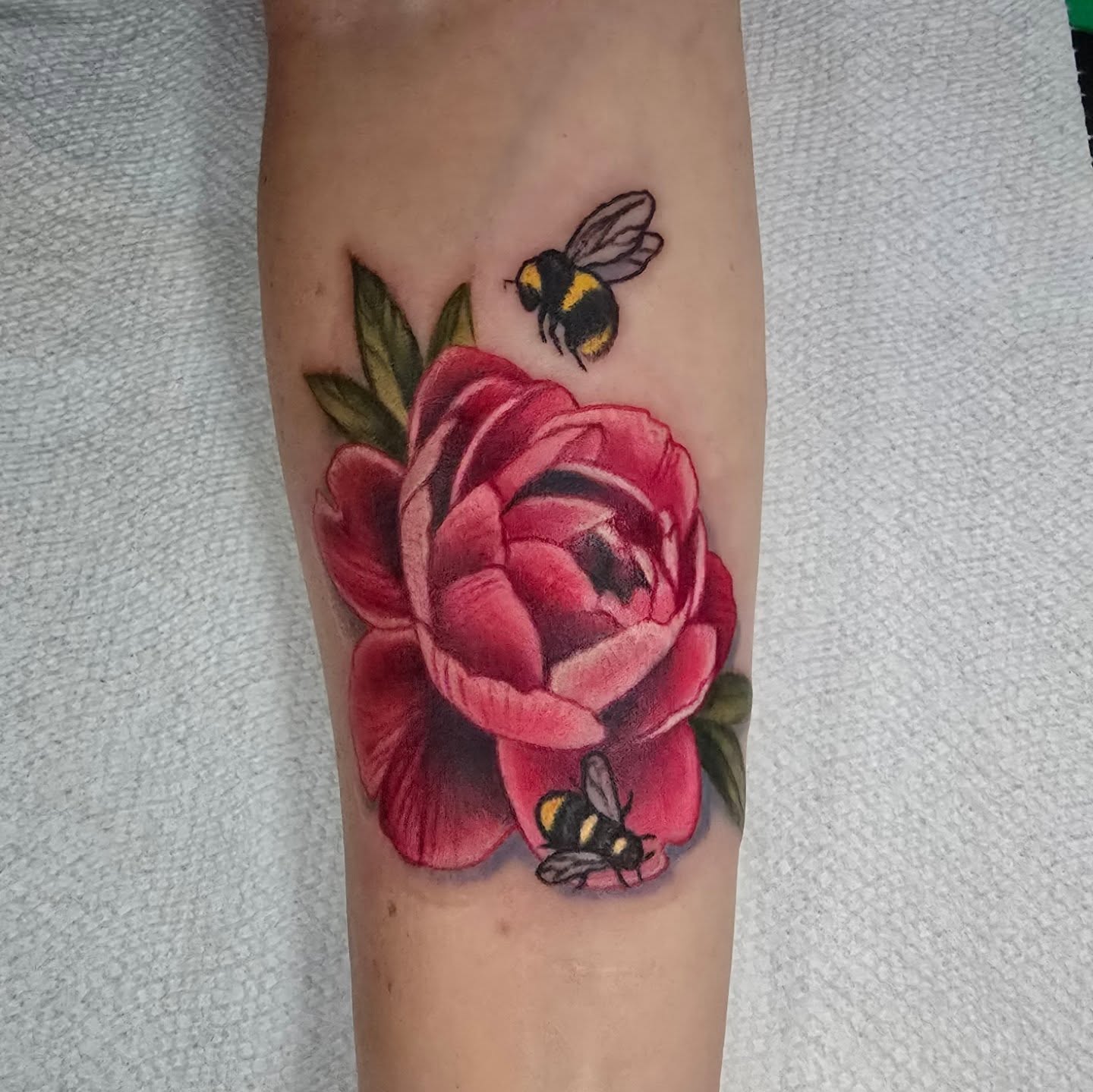 Peony and bees realism tattoo on the forearm by Tivis Phillips