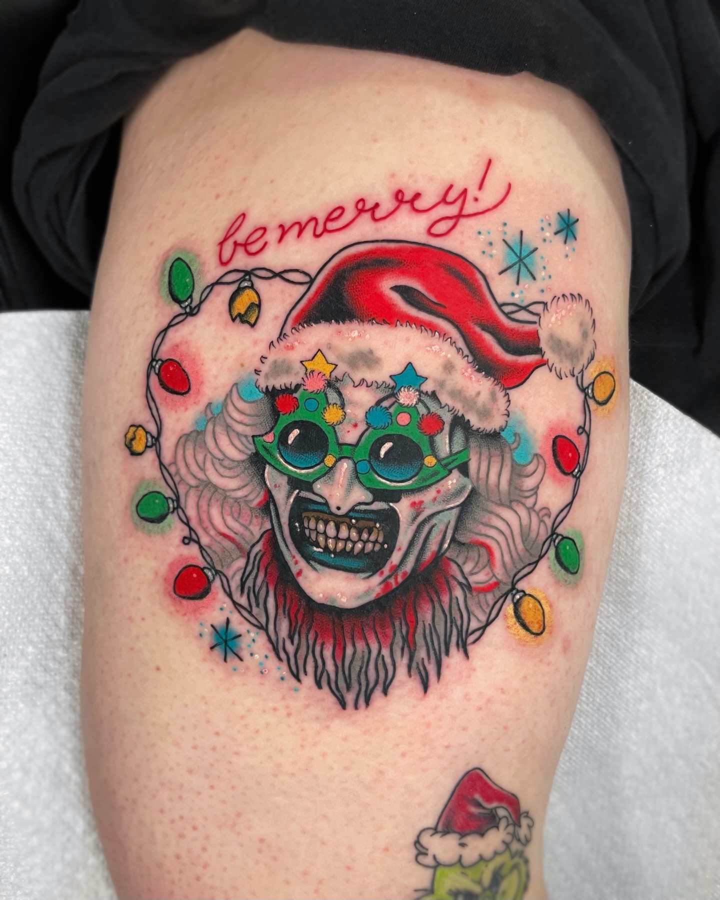 Clown with Santa hat American traditional tattoo on the thigh by 𝕬𝖓𝖆𝖇𝖊𝖑𝖑 𝕸𝖔𝖗𝖔