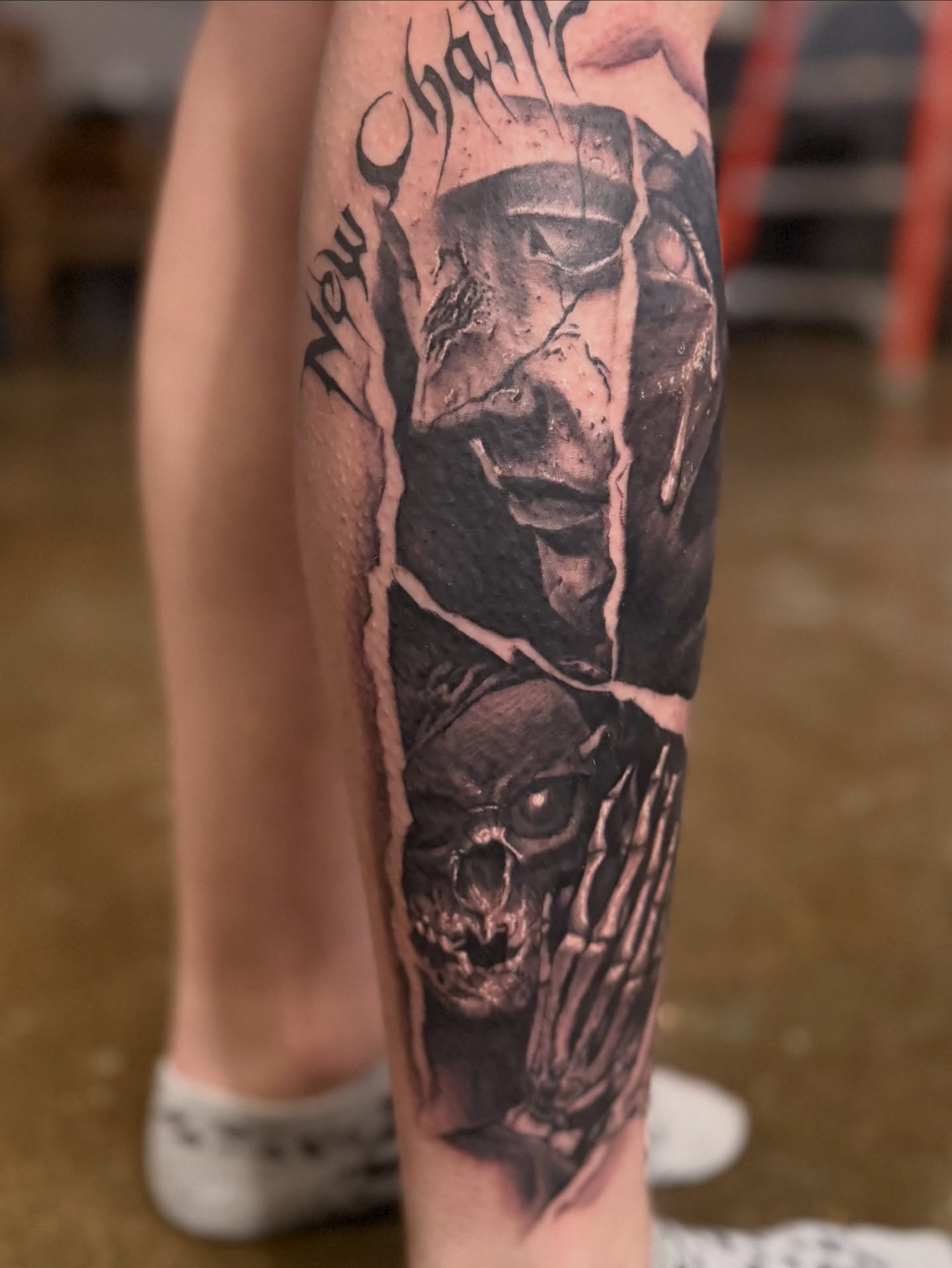 Skull and flame realism tattoo on the calf by Miles Haysmith