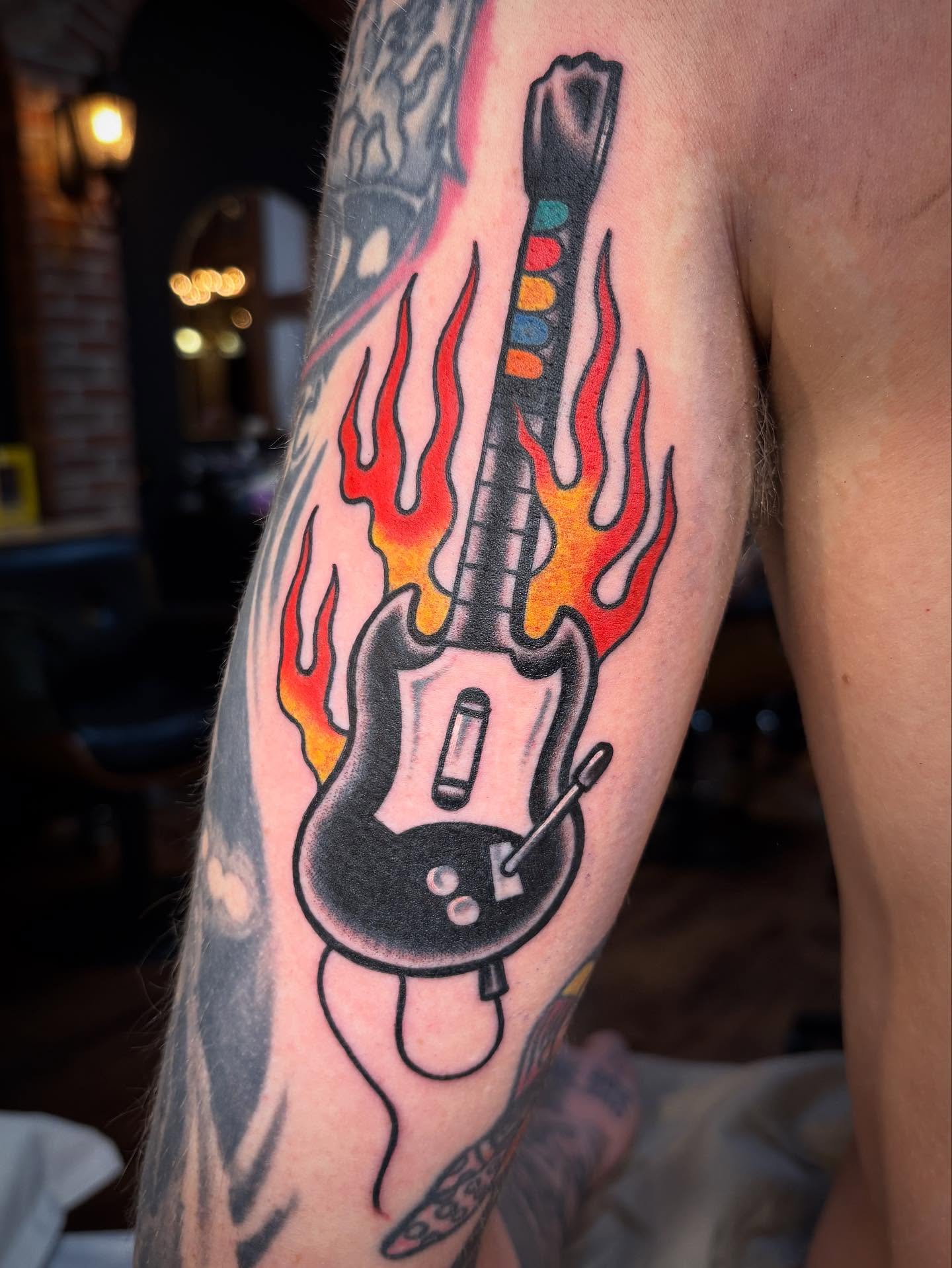 Electric guitar new school tattoo on the forearm by Tom Wenzell