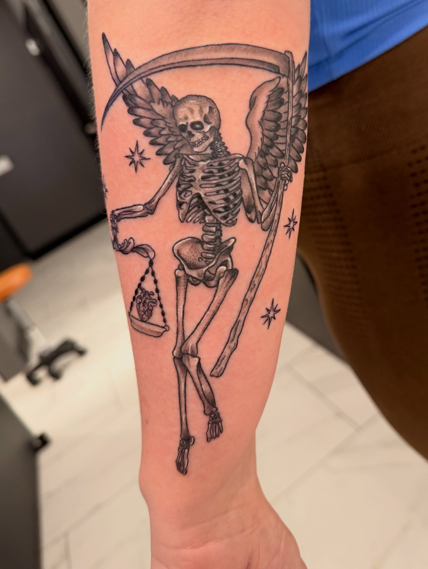 Skeleton with scales black and grey tattoo on the forearm by Lexi Odam