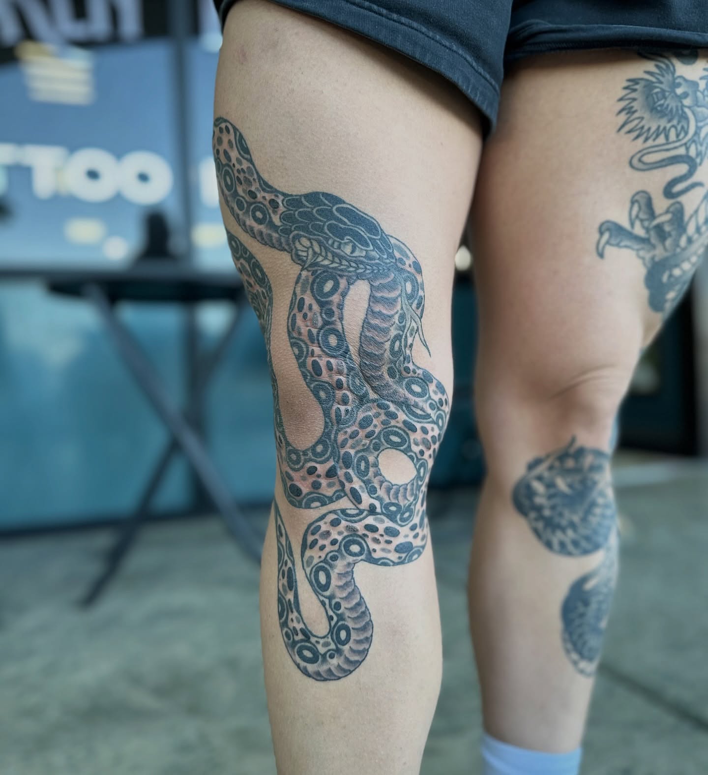 Snake dotwork tattoo on the thigh by Walk-in American Traditional Tattoos Las