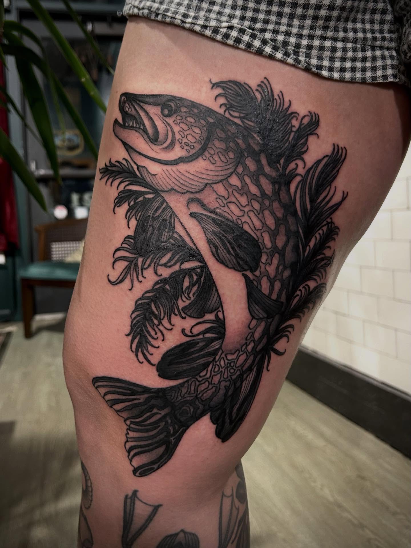 Fish black and grey tattoo on the thigh by ꧁𝙺𝚊𝚛𝚒𝚗𝚊꧂, Grinnell, Iowa