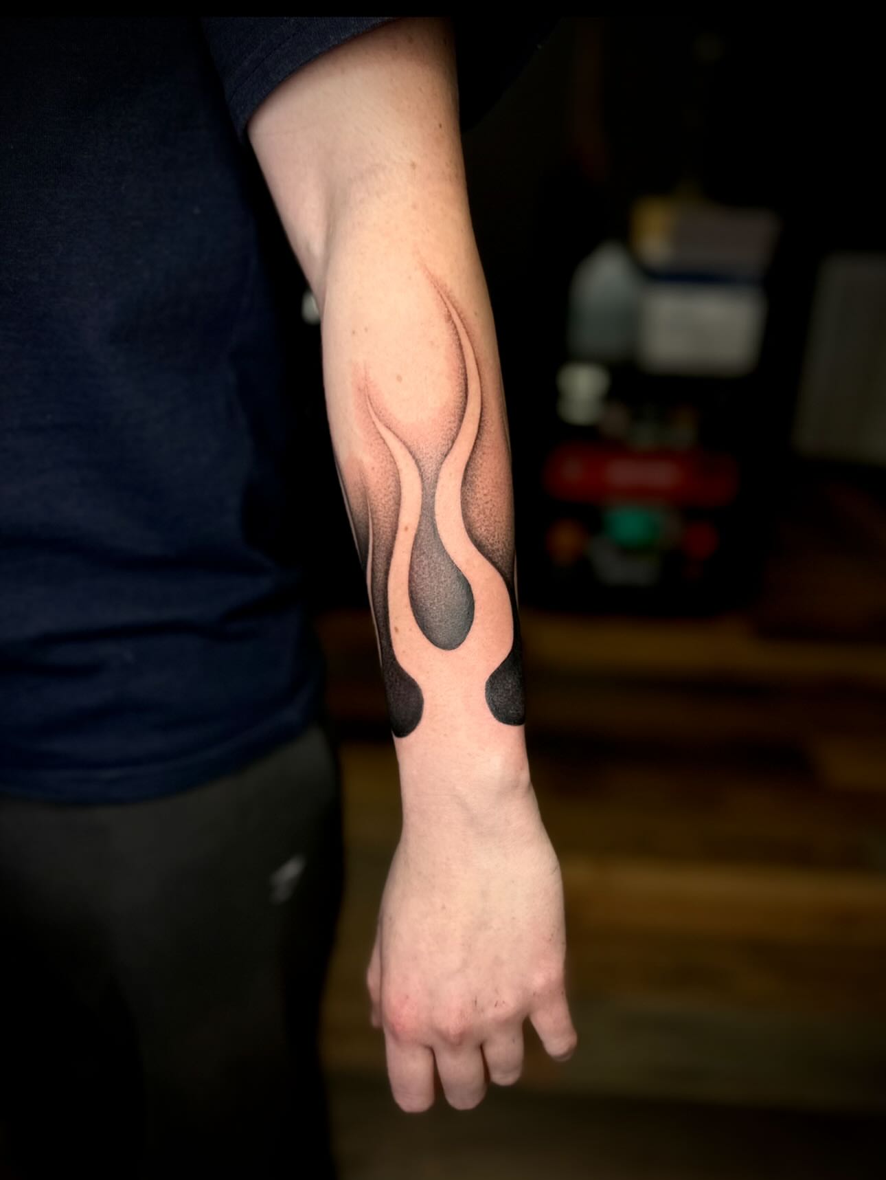 Flame dotwork tattoo on the forearm by Madison Orchard Tattoos