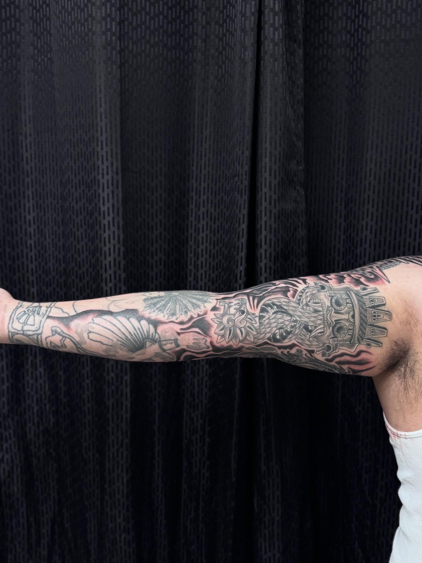 Religious iconography black and grey tattoo on the forearm by Jacob - Tattoo Artist