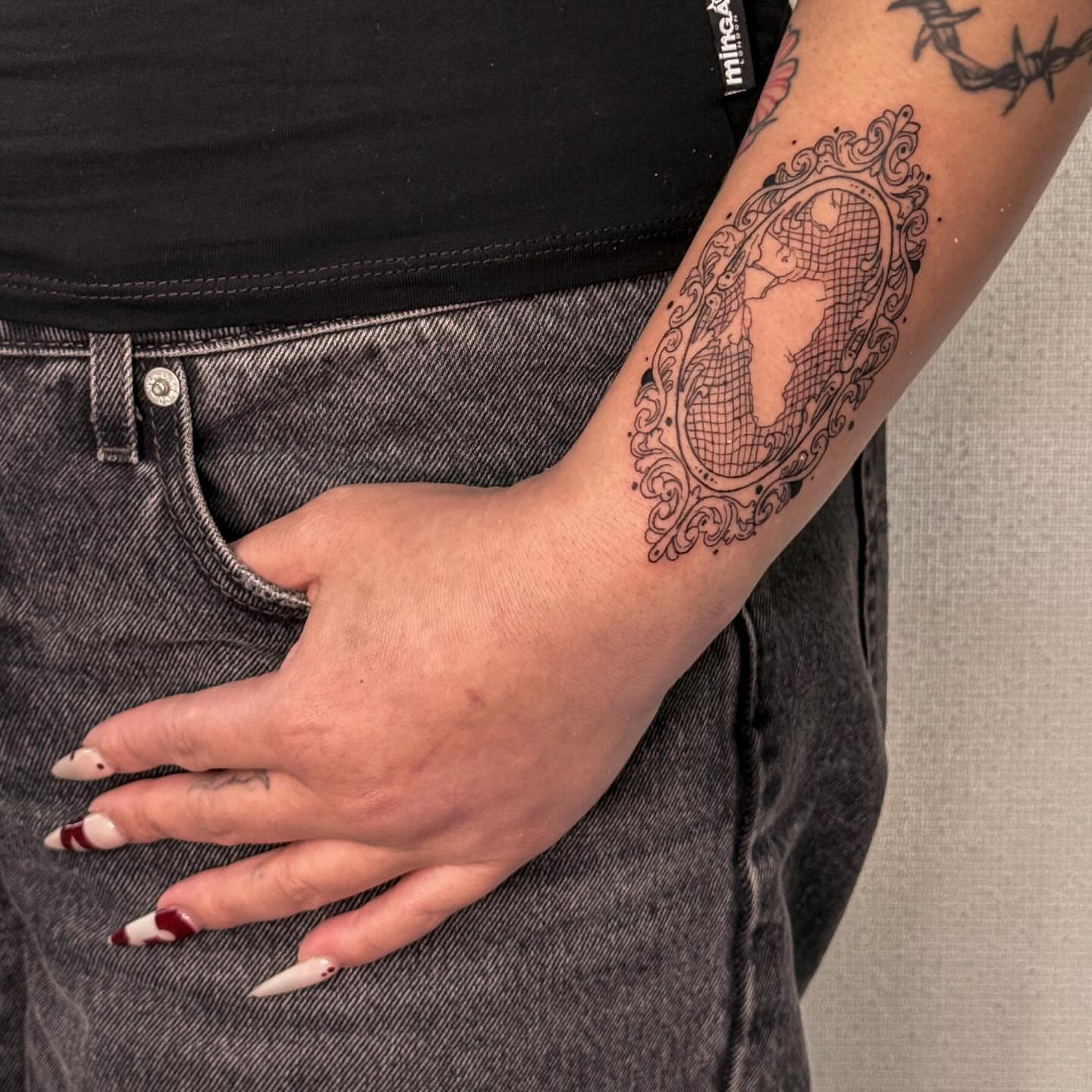 World map black and grey tattoo on the forearm by Las Vegas Tattoo Artist