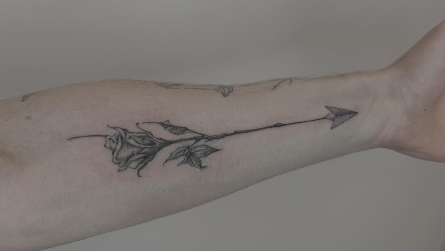 Rose with arrow black and grey tattoo on the forearm by Van Cleave Aesthetics, Franklin, Tennessee