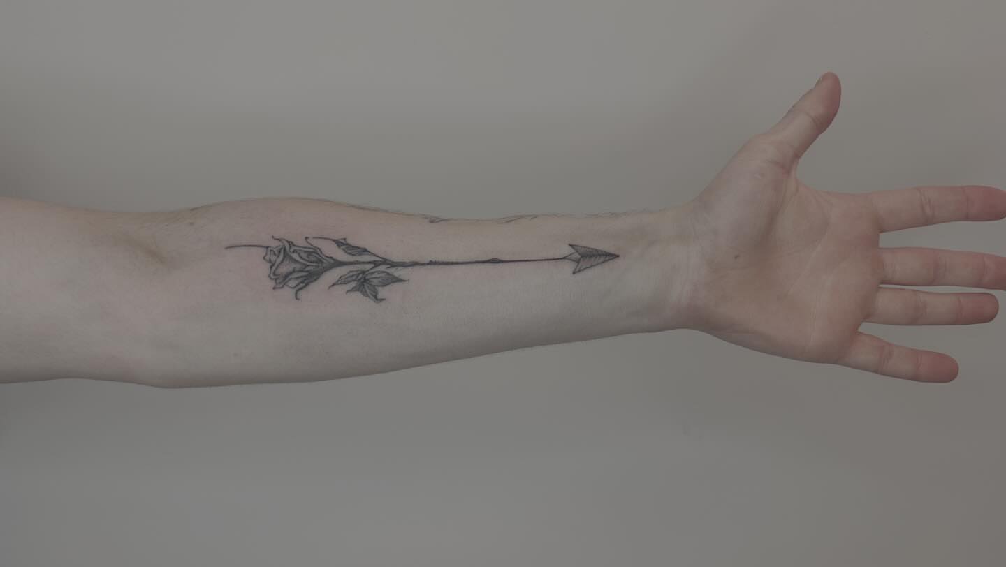 Arrow with rose black and grey tattoo on the forearm by Van Cleave Aesthetics, Franklin, Tennessee