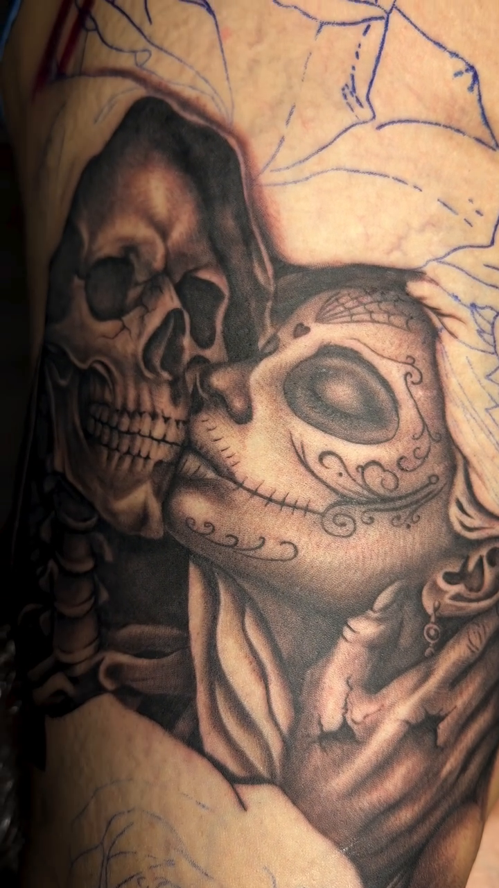 Two skulls in an embrace dark realism tattoo by Denver Tattoo Artist
