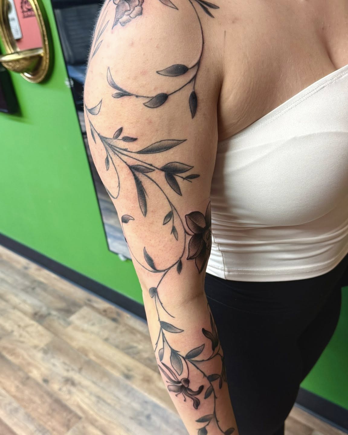 Floral vine black and grey tattoo on the upper arm by Josh Roberts, Franklin, Ohio