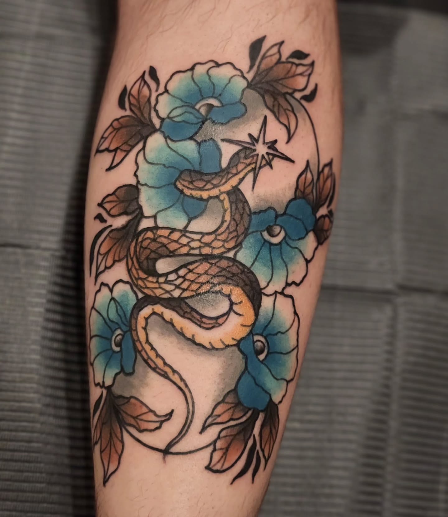 Snake and flowers American traditional tattoo on the forearm by Sonya ๐ฟ๐ธ๐พ