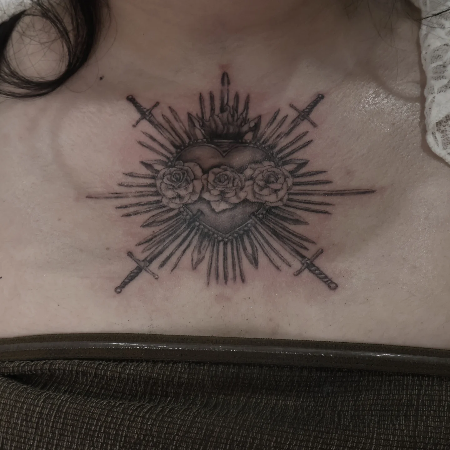 Heart with roses and swords black and grey tattoo on the chest by Joc