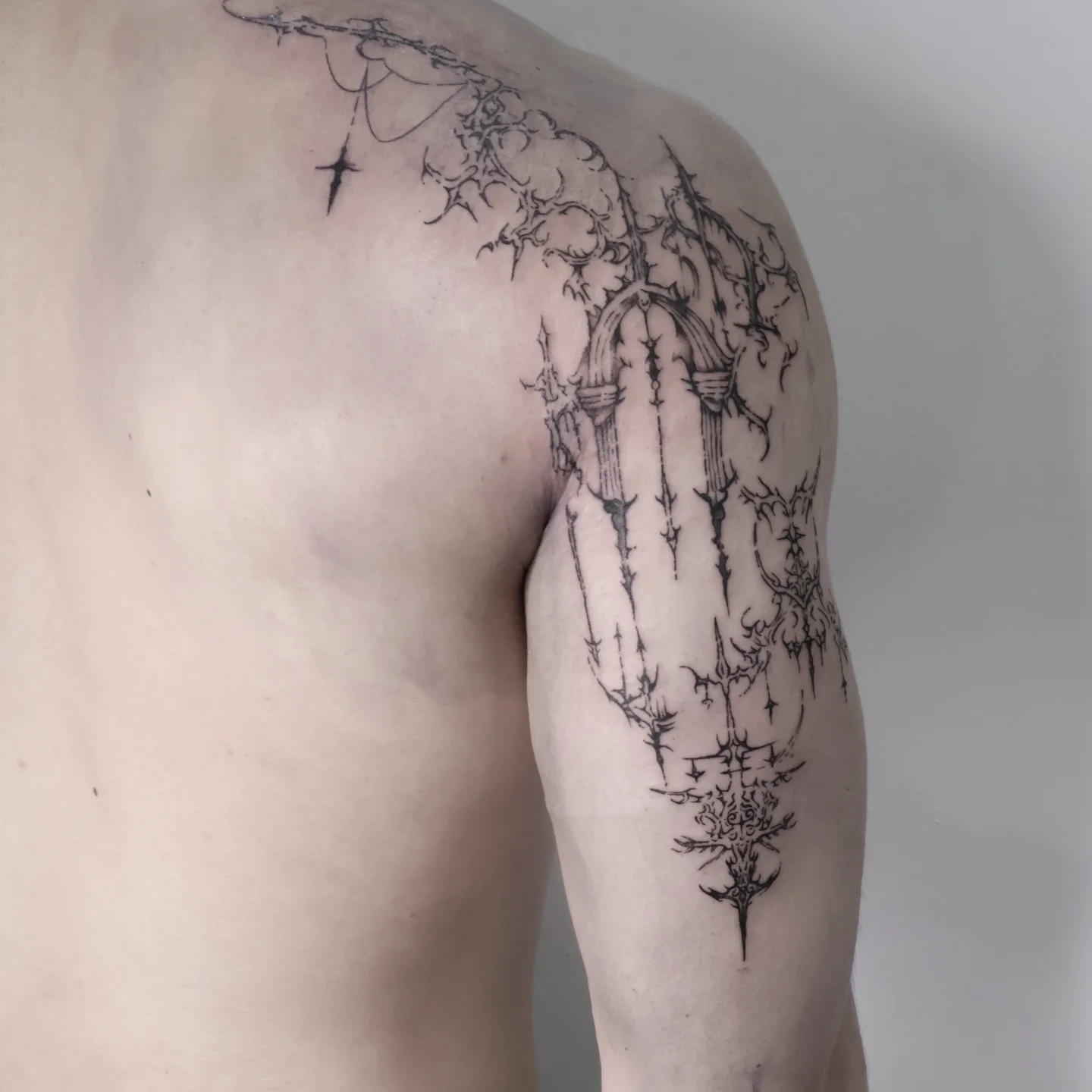 Thorns and thistle black and grey tattoo on the shoulder by Joc
