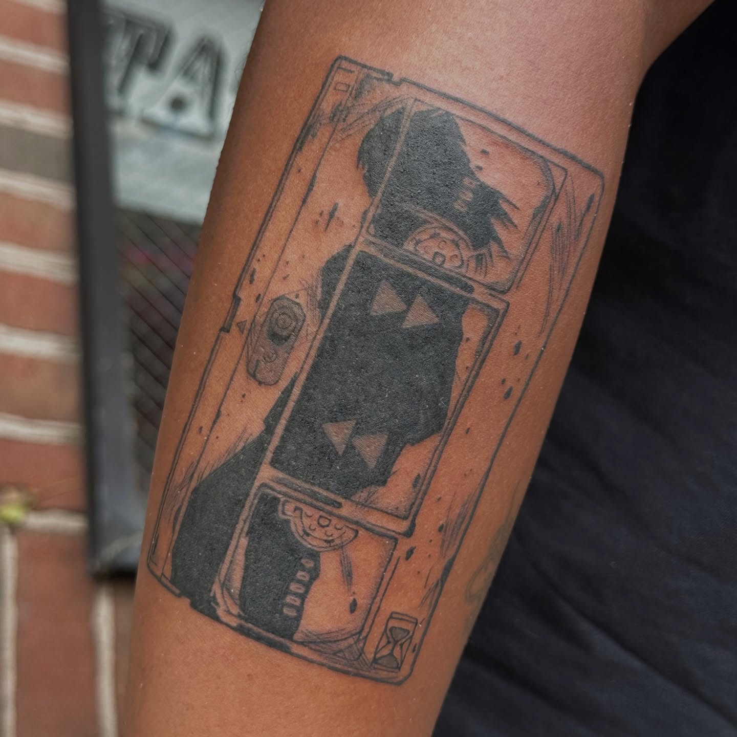 Arcade machine black and grey tattoo on the forearm by kira